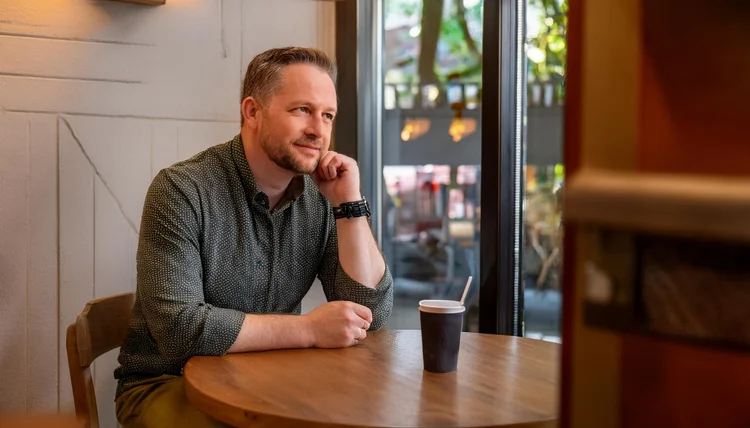 Man sitting comfortably alone in a coffee shop