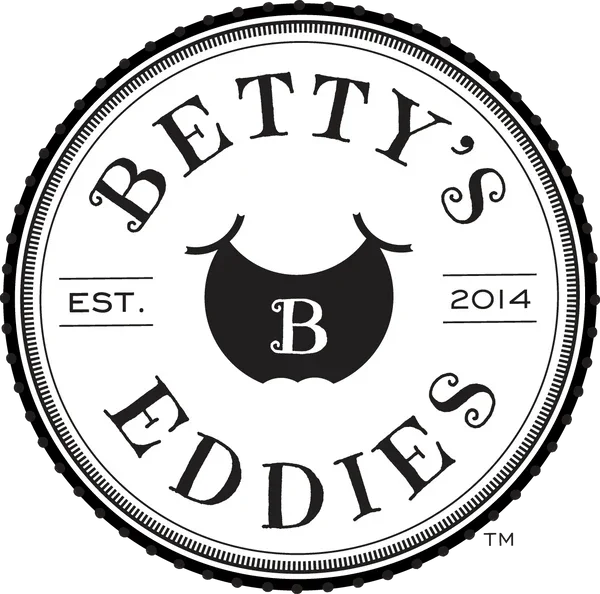 Logo for Betty's Eddies, established in 2014, featuring a black circle with a stylized cows udder and the letter B in the center.