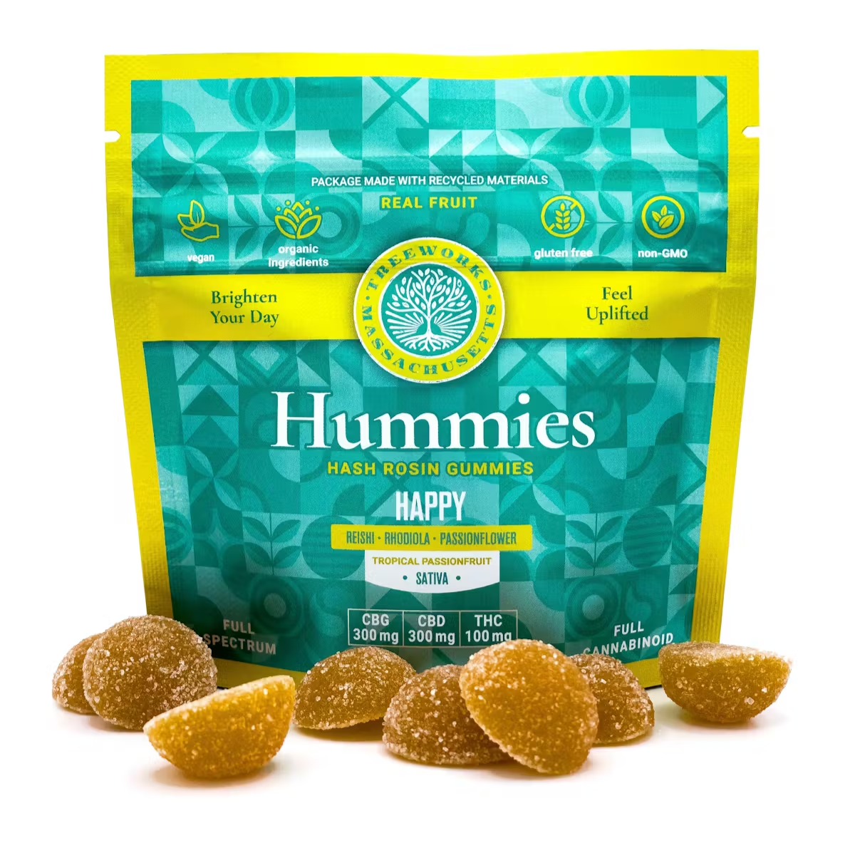 A package of Hummies hash rosin gummies in front of a white background. The package is teal and yellow with text indicating the gummies are made with real fruit, vegan, organic ingredients, gluten free, and non-GMO. Several hash rosin gummies are displayed in front of the package.