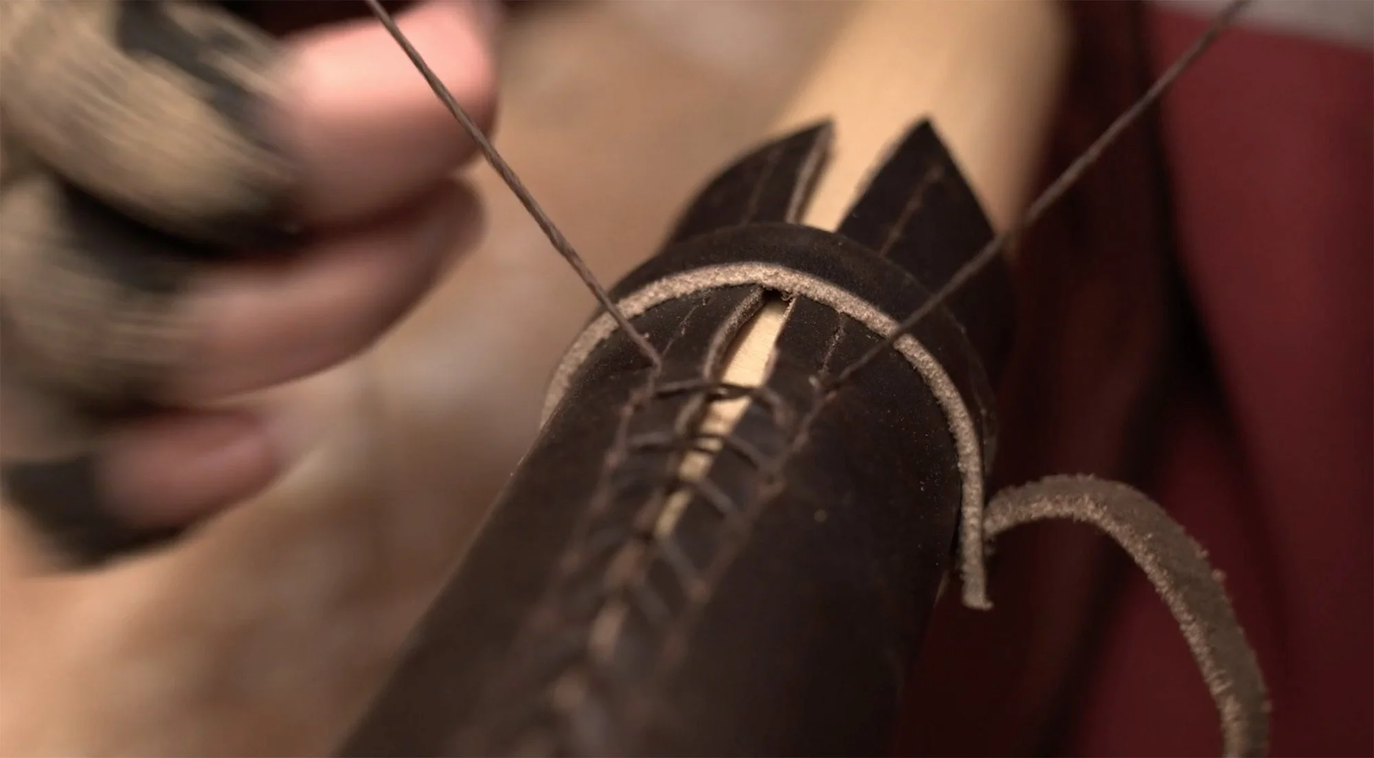 Close-up of hand-stitched leather grip on Shaw & Tenney oar showing craftsmanship detail