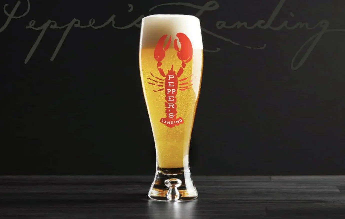 Pepper's Landing brand identity development sample lifestyle interior layout with beer glass in dark setting, design by Murphy
