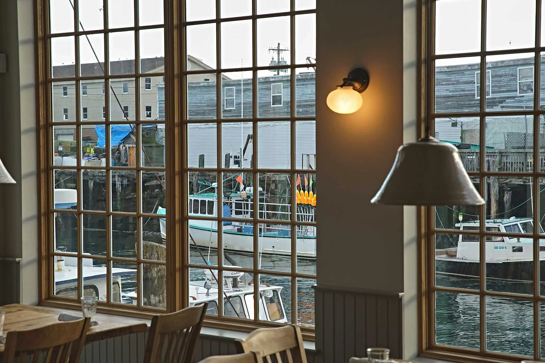 View from inside Scales Restaurant overlooking Portland Maine waterfront through large windows.