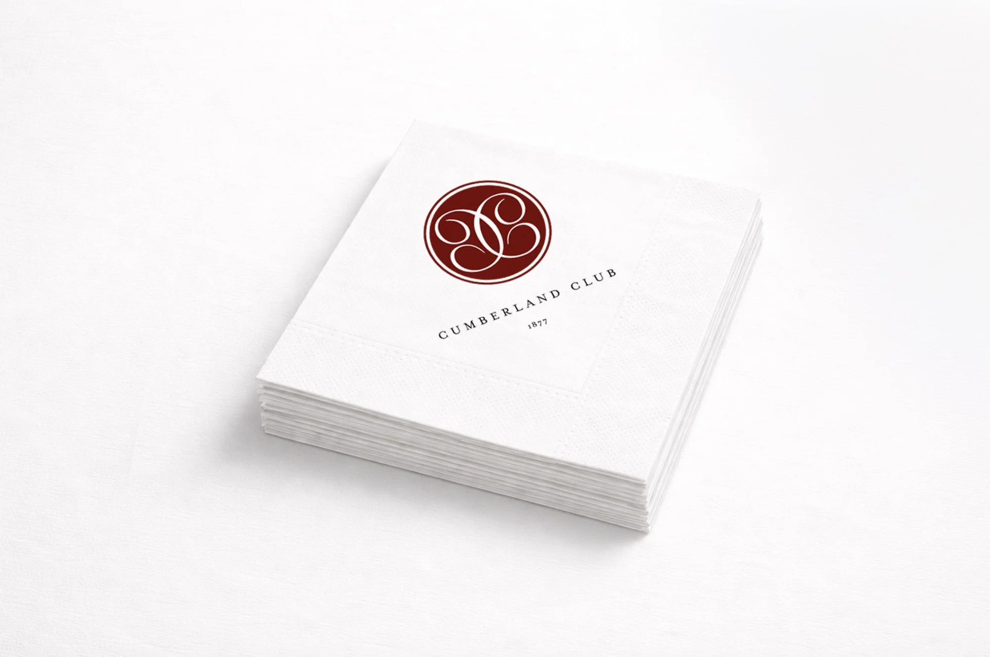 Cumberland Club branded cocktail napkins with embossed seal