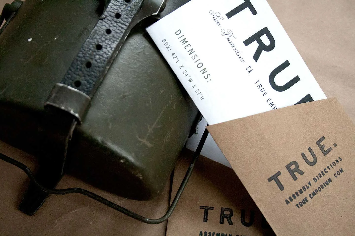 True Emporium print collateral in lifestyle setting with vintage military props, design by Murphy