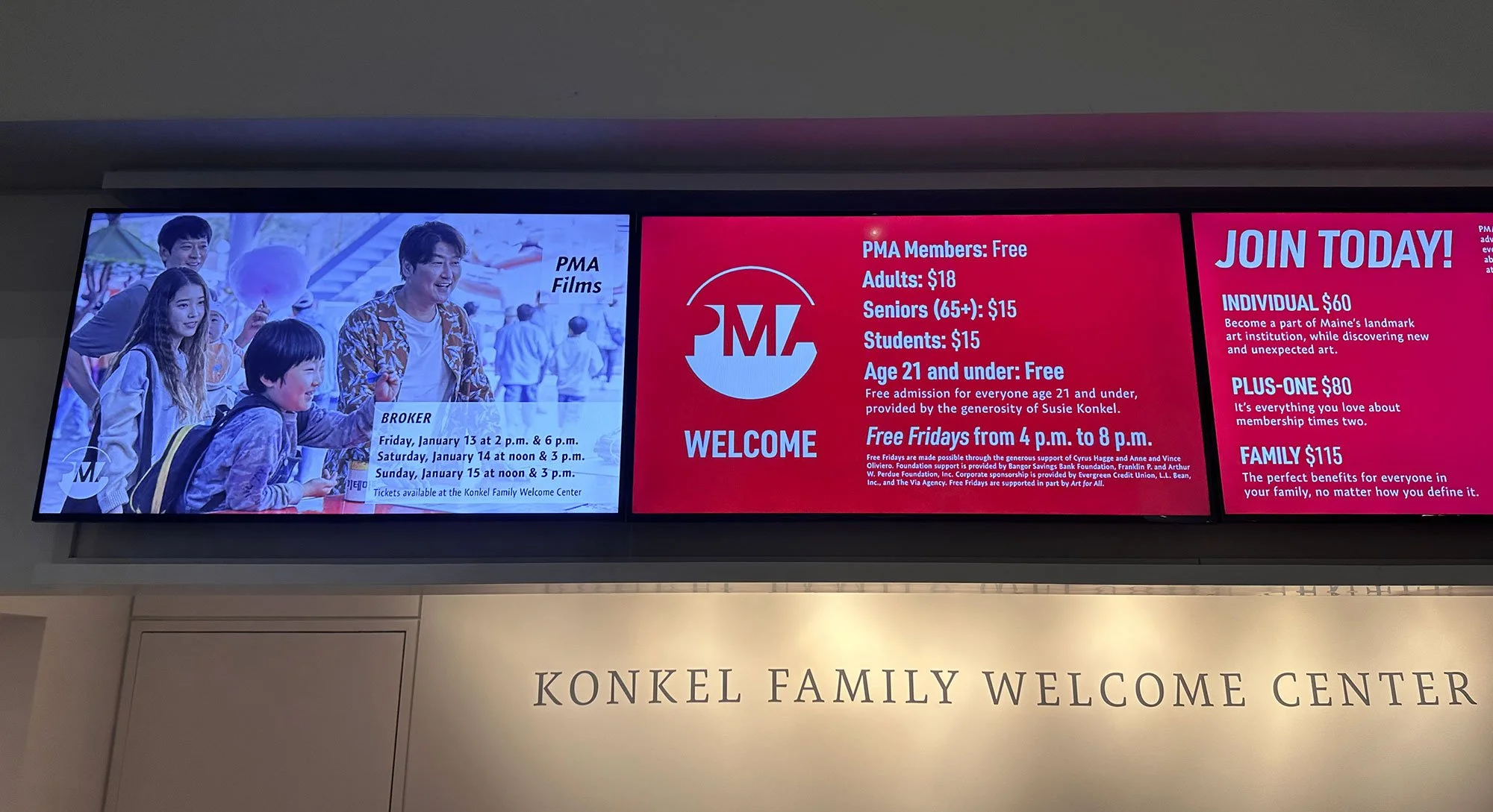 Digital welcome screens displaying Portland Museum of Art visitor information inside the museum