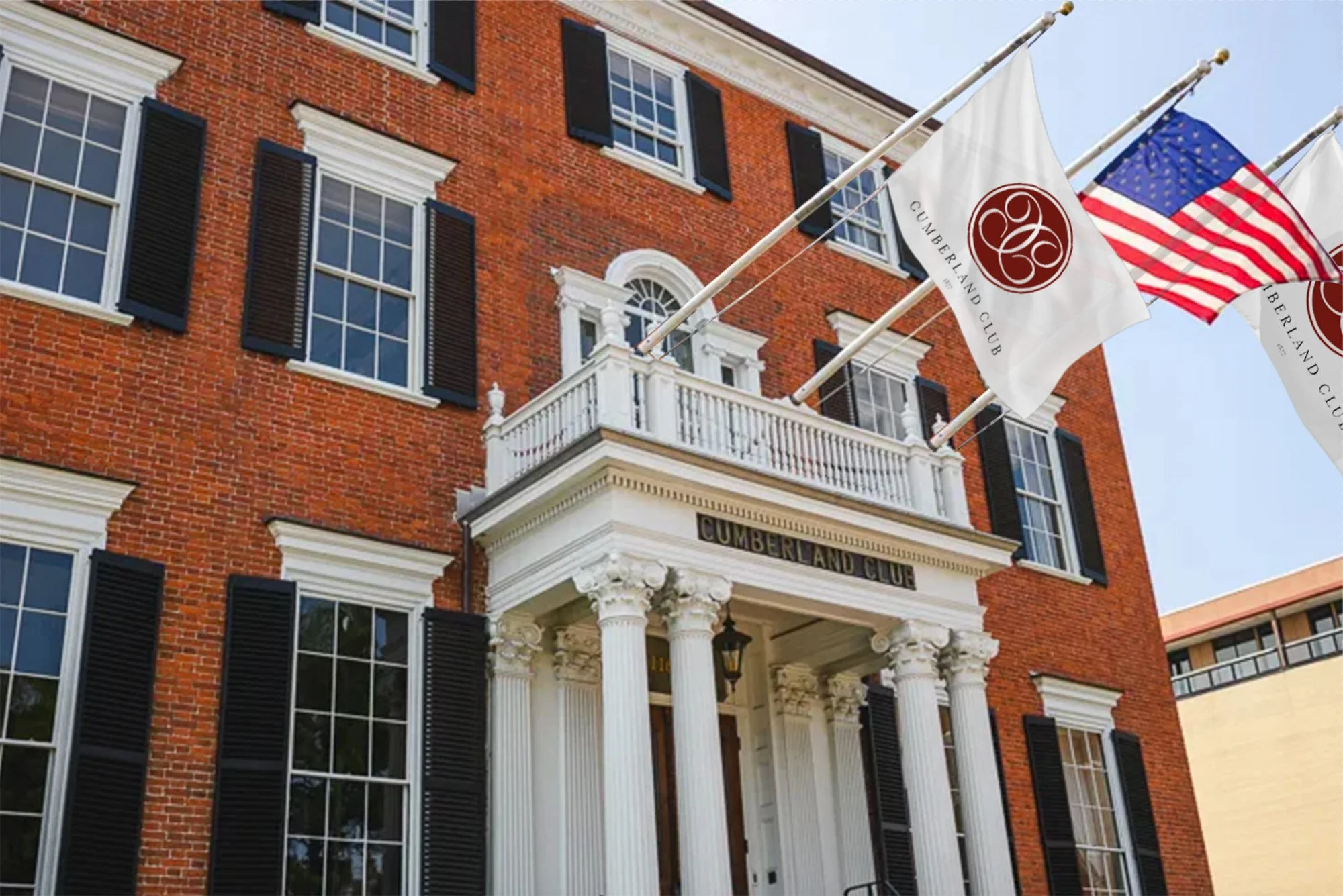 Cumberland Club historic building façade with branded flags, Portland Maine