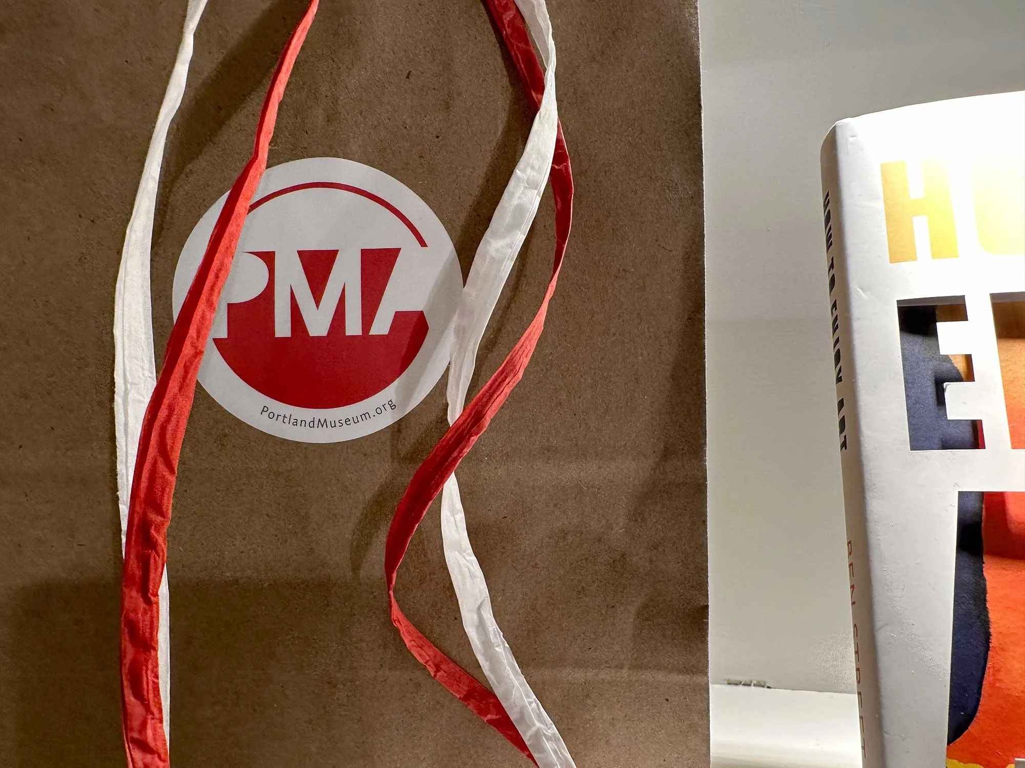 Close-up of printed museum materials featuring the Portland Museum of Art visual identity