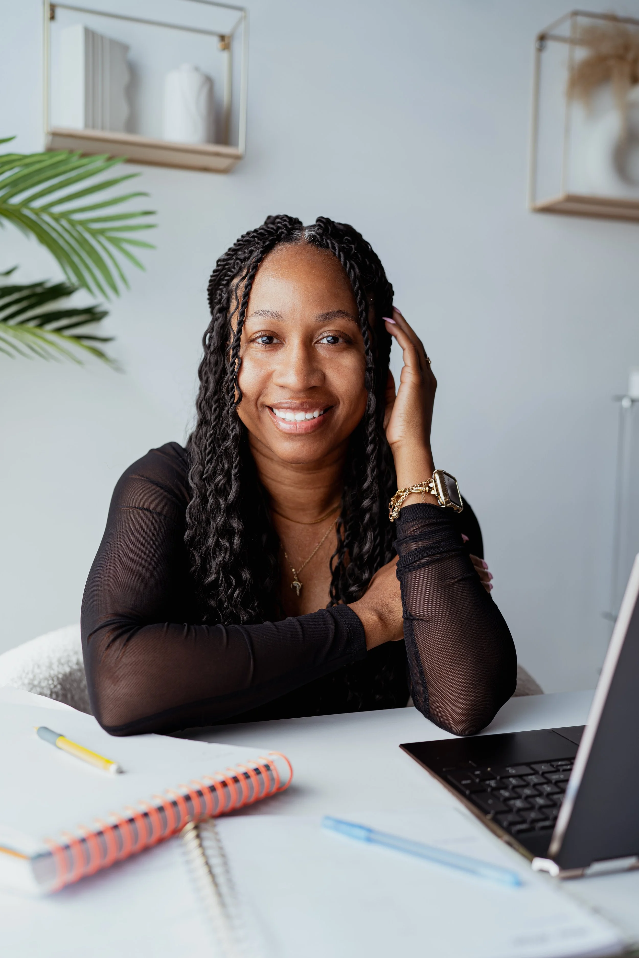 Charity Mahone, Black woman web designer and digital strategist, smiling during a photoshoot in her Atlanta studio