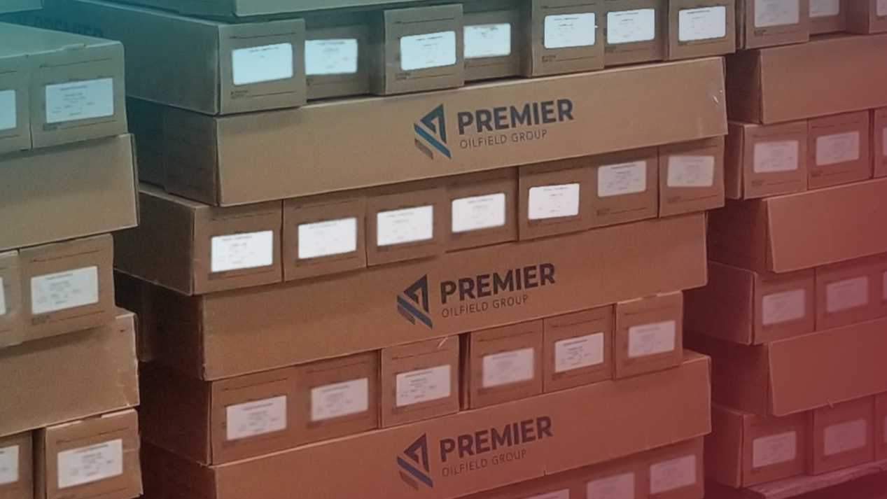 Stacks of cardboard core boxes labeled 'Premier Corex' placed on pallets in a warehouse.