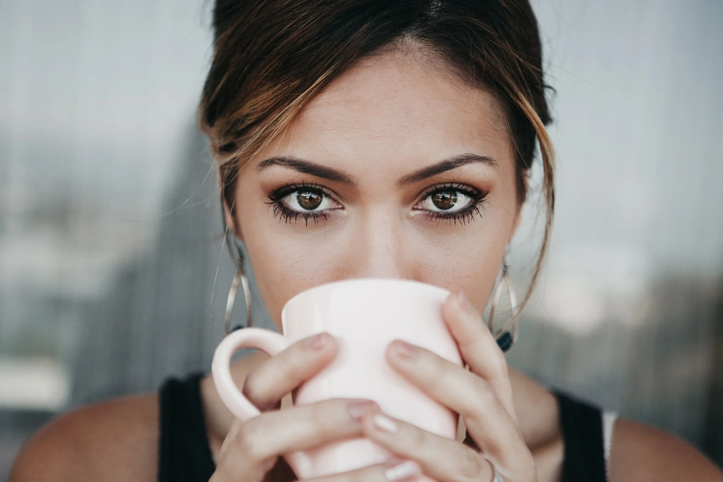 lady looking at your with coffee mug