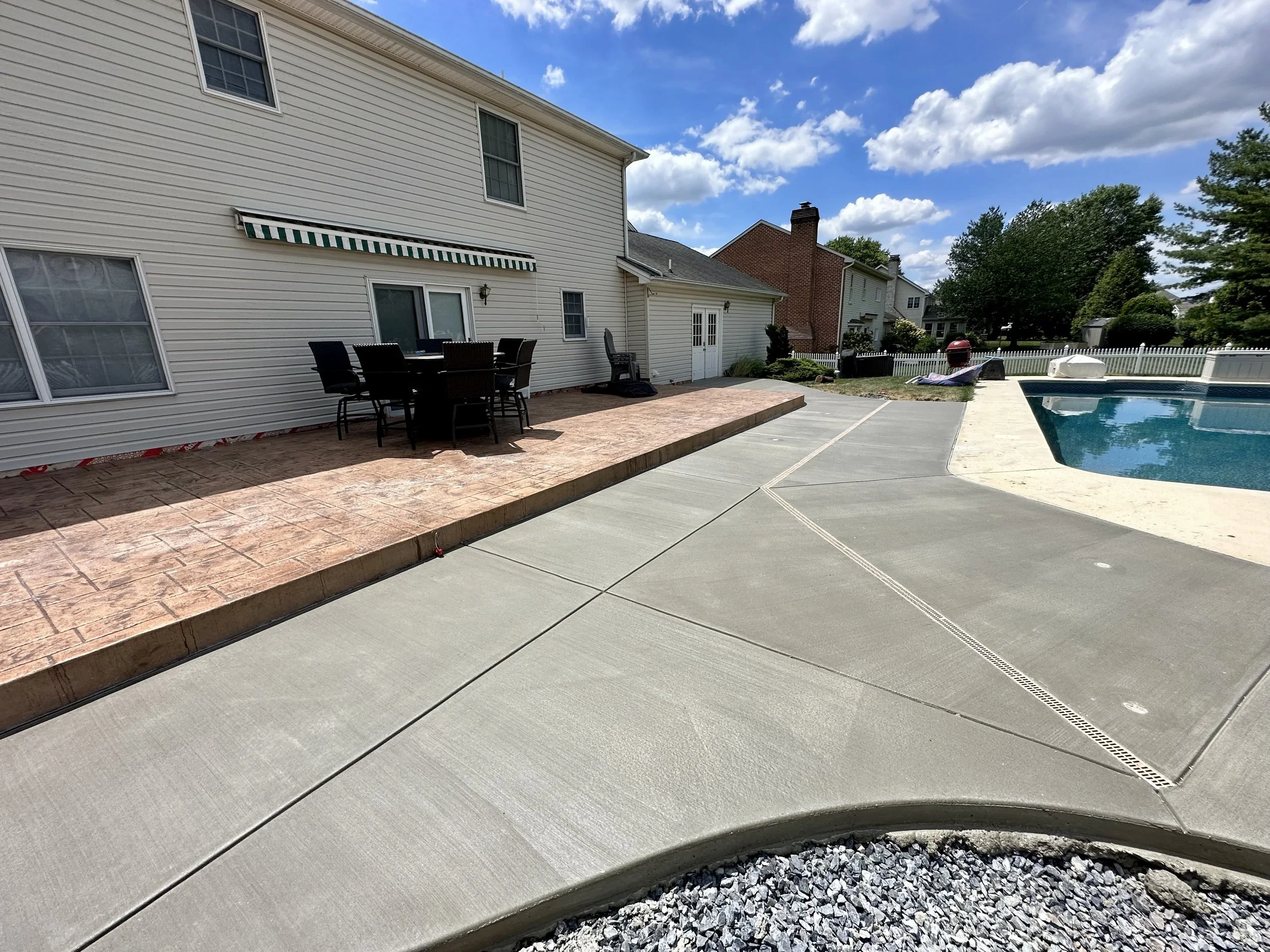 Multilevel stamped and broomed pool surround with drain and umbrella receivers.  Curved sun chair area not shown.  Mechanicsburg, PA