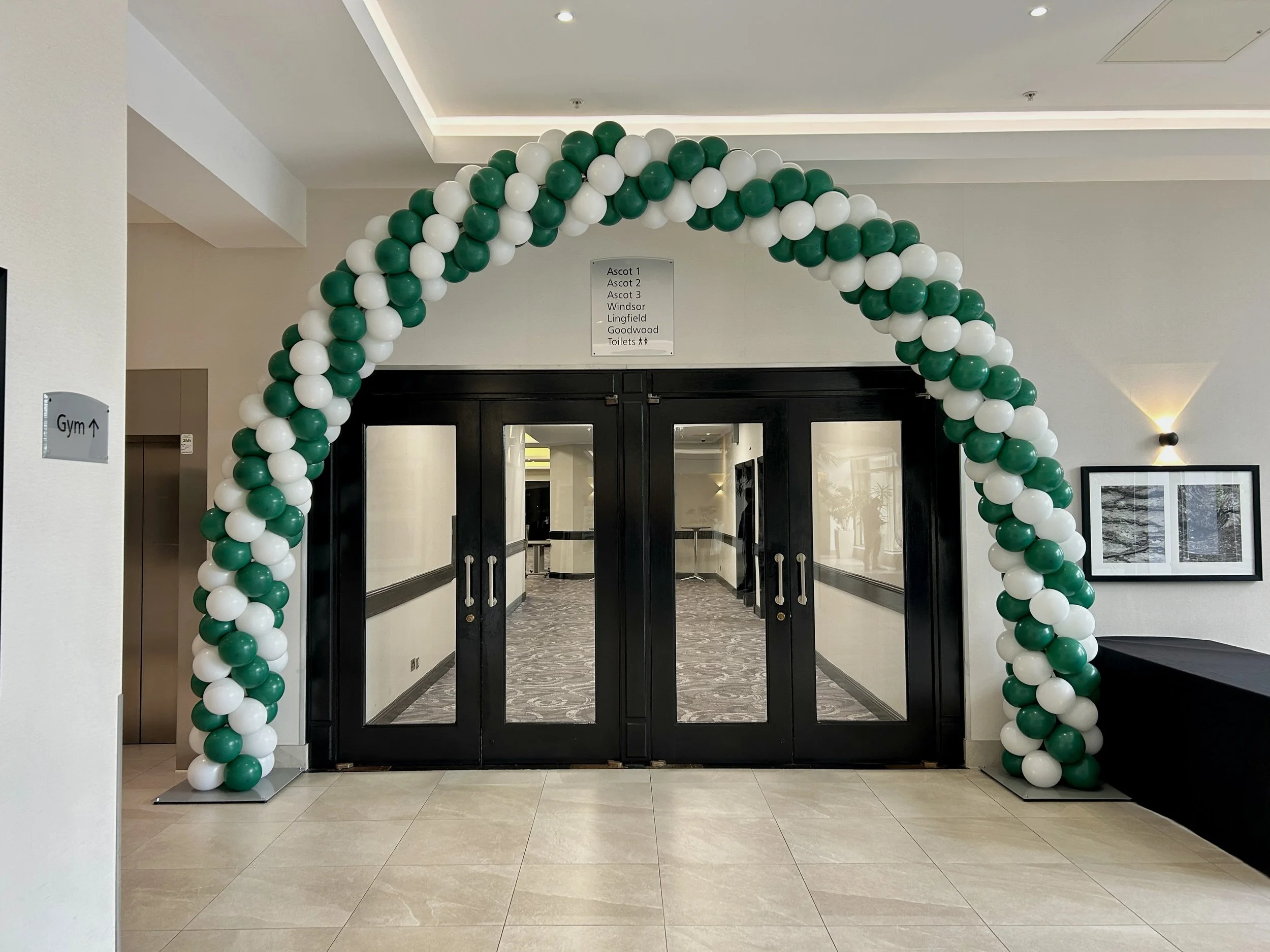 green and white balloon arch for a corporate event 