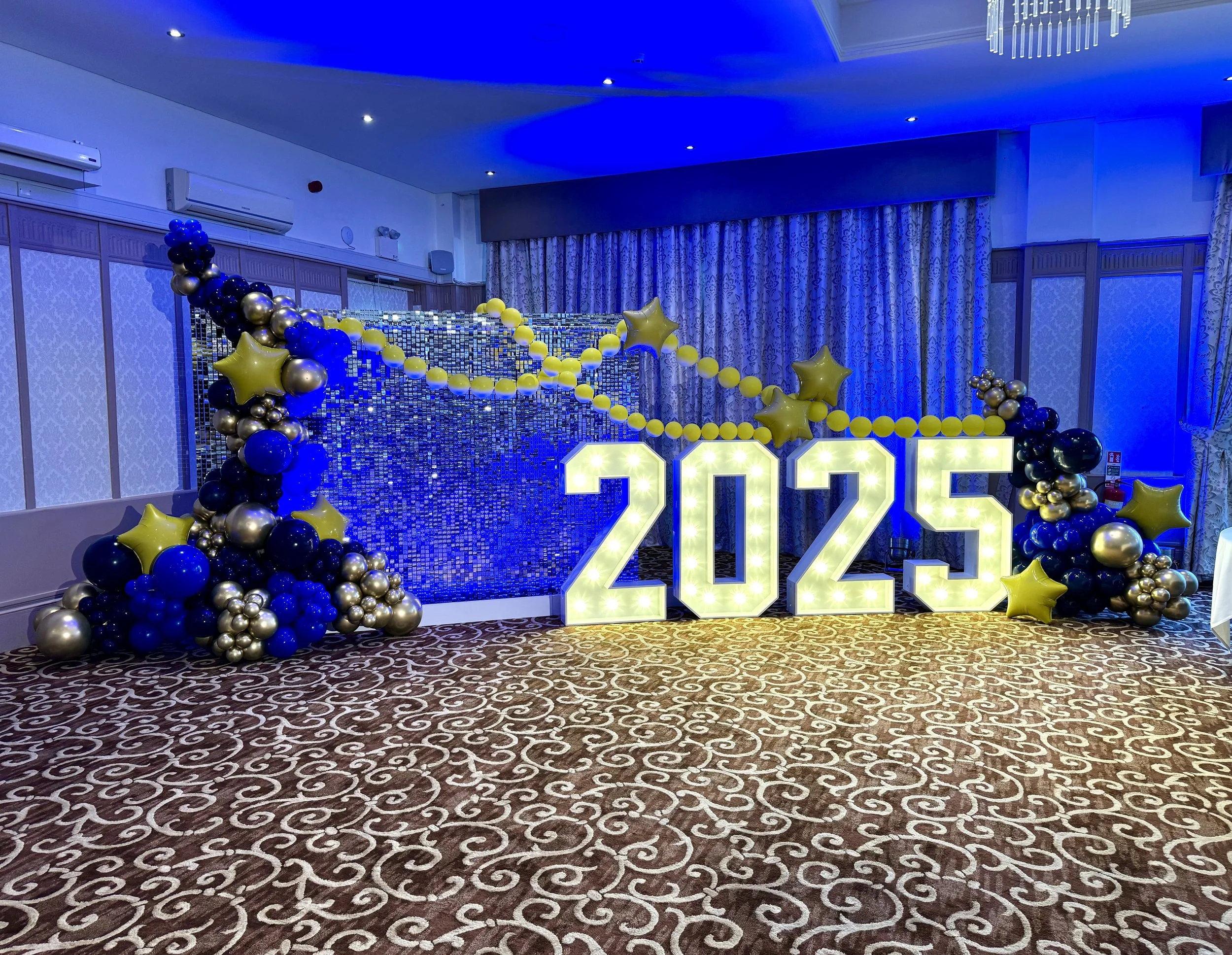 Charity event for Queen Victoria Hospital  awards evening in Felbridge using light up numbers shimmer walls and balloon garland 