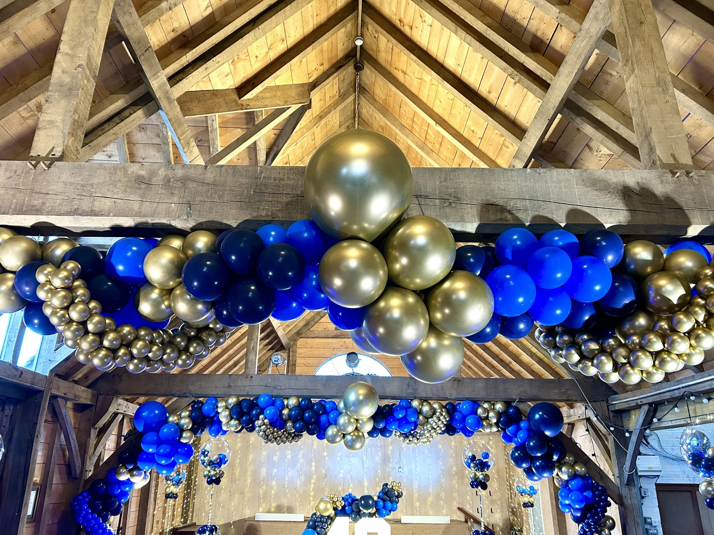 gold blue and navy balloon garland for a 40th birthday at the yogurt rooms in east grinstead