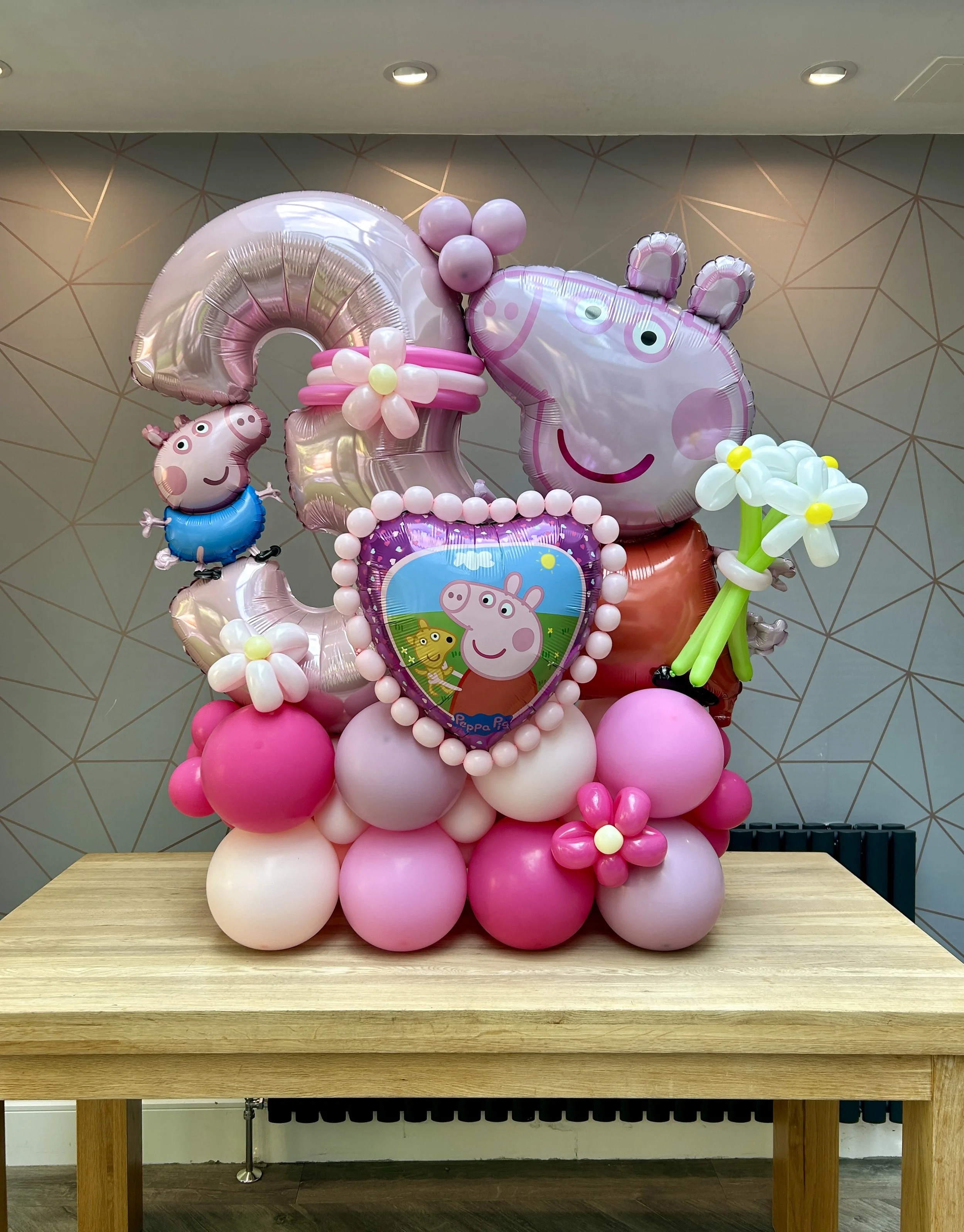 Peppa pig themed balloon stack for a 3rd birthday celebration