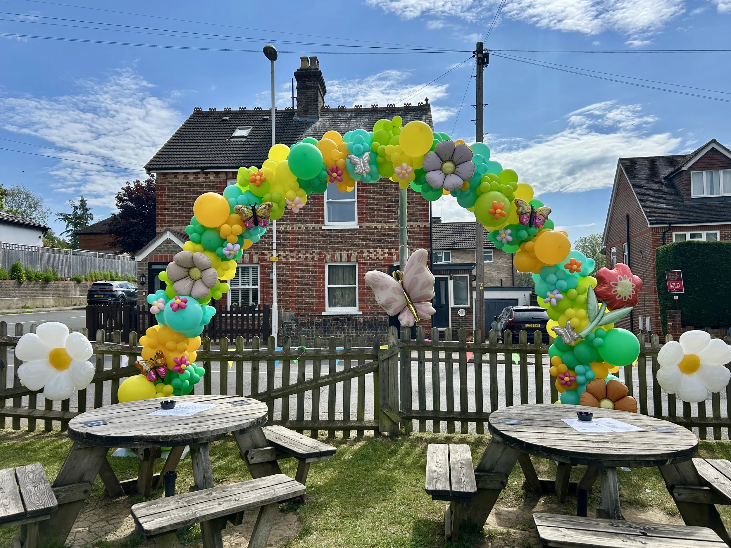 spring themed balloon arch at the old runnings mill pub in east grinstead for a music festival event 