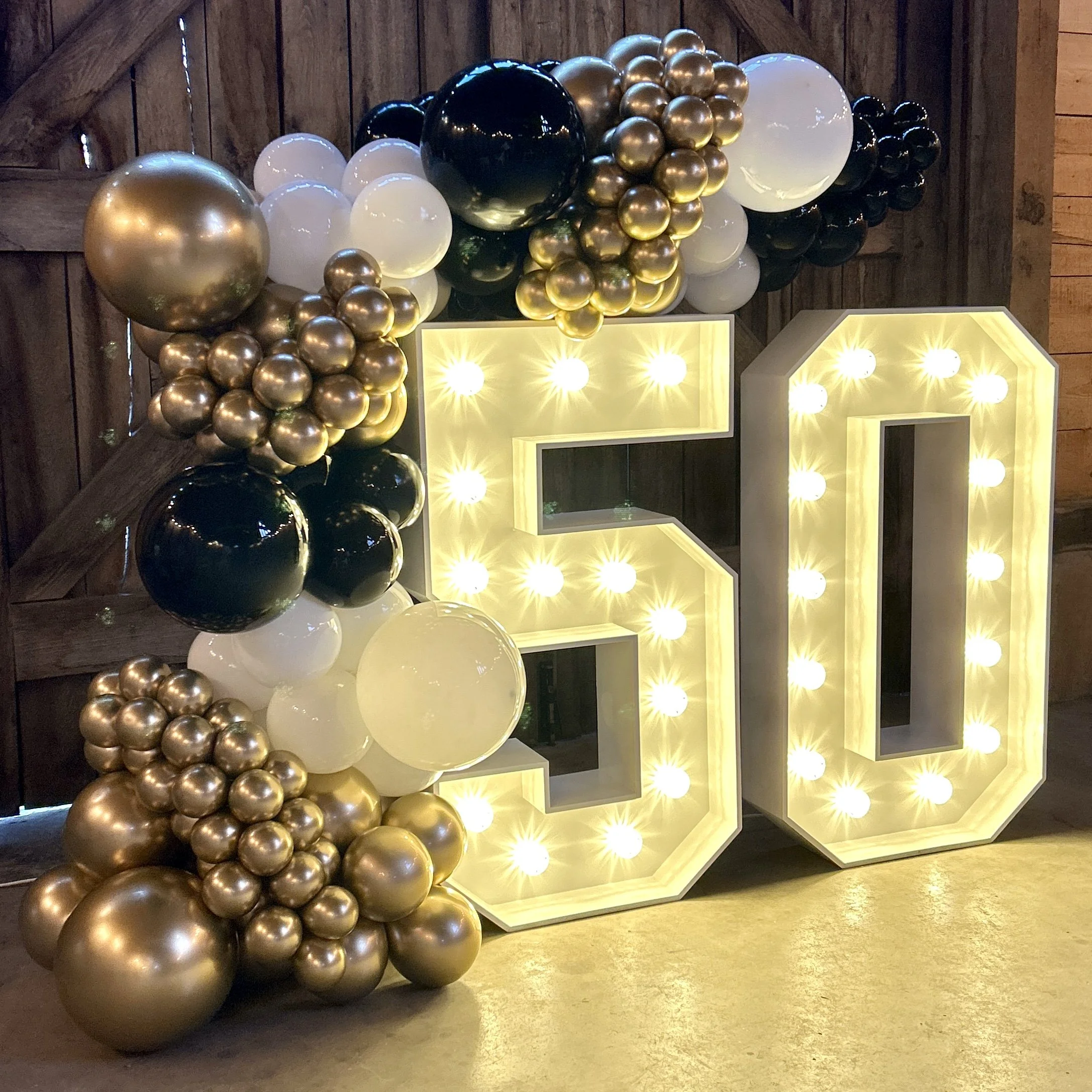 light up number 50 with gold black and white balloons
