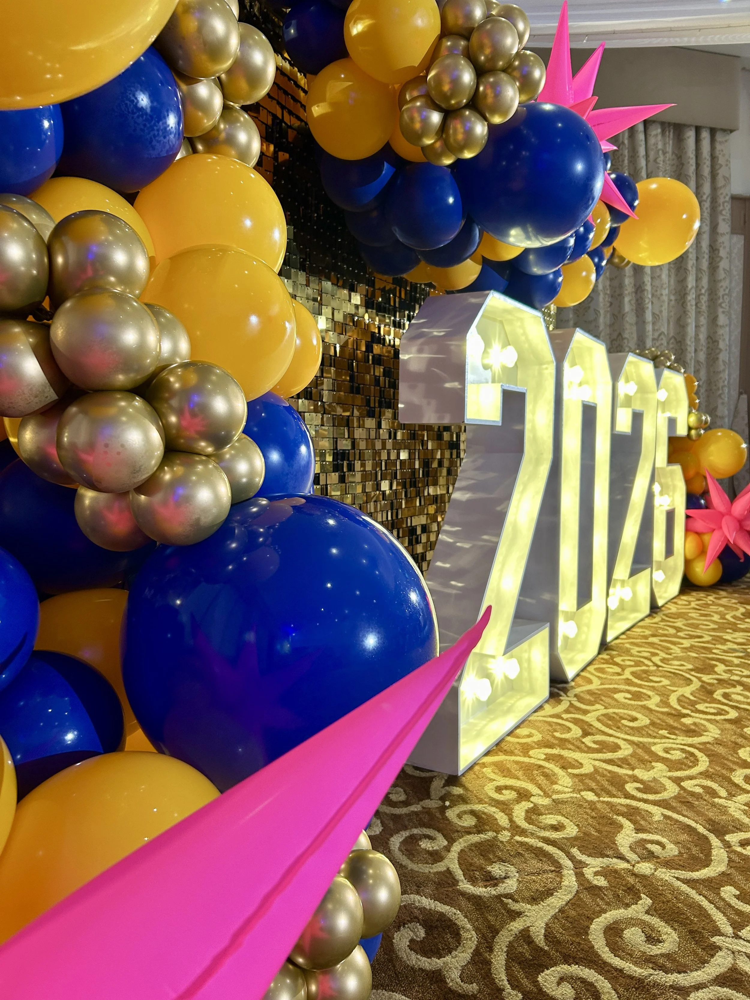 yellow and blue ballon garland with light up numbers at the felbridge hotel in east grinstead