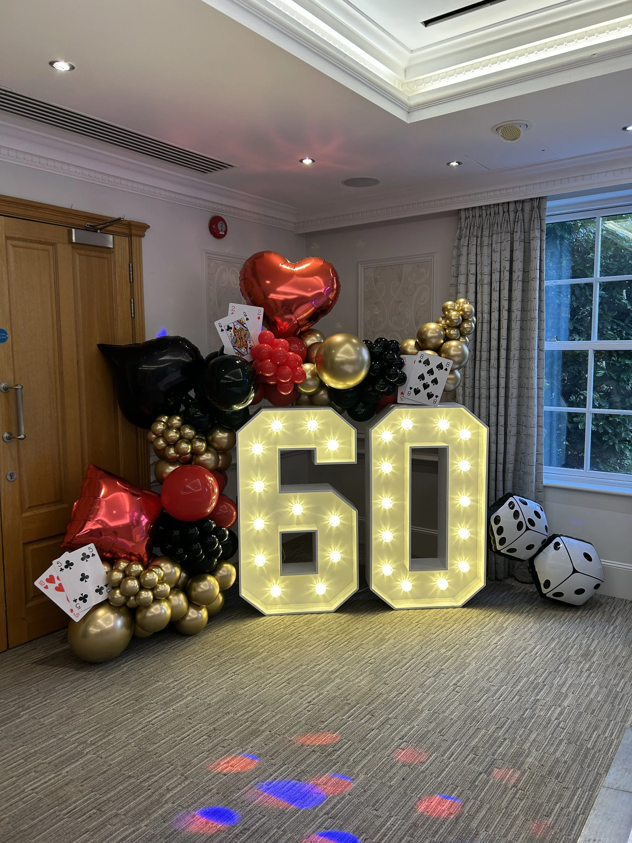 light up 60 with black and red balloons and added dice and playing cards