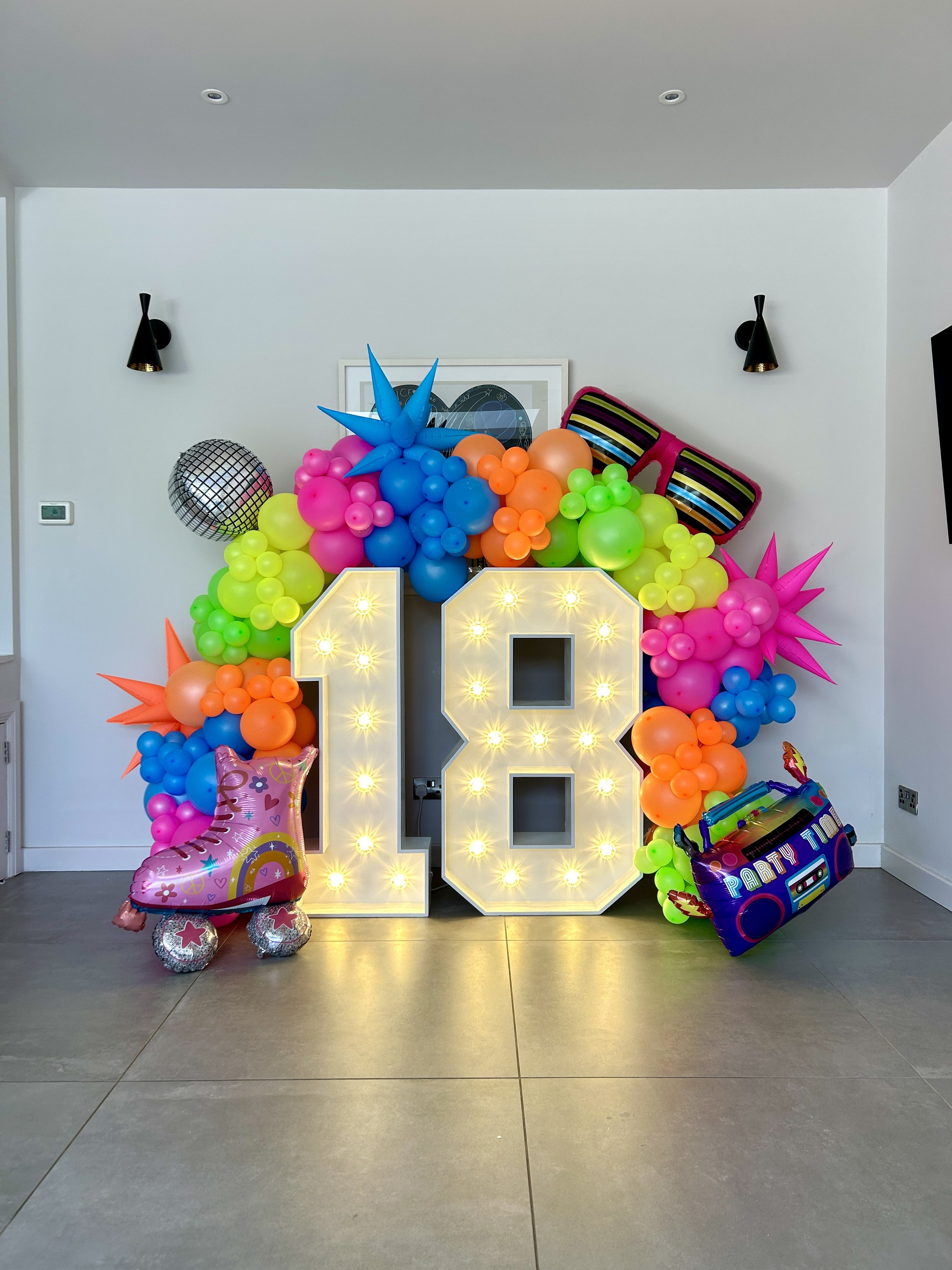 light up 18 with 80's inspired ballon garland in tunbridge wells