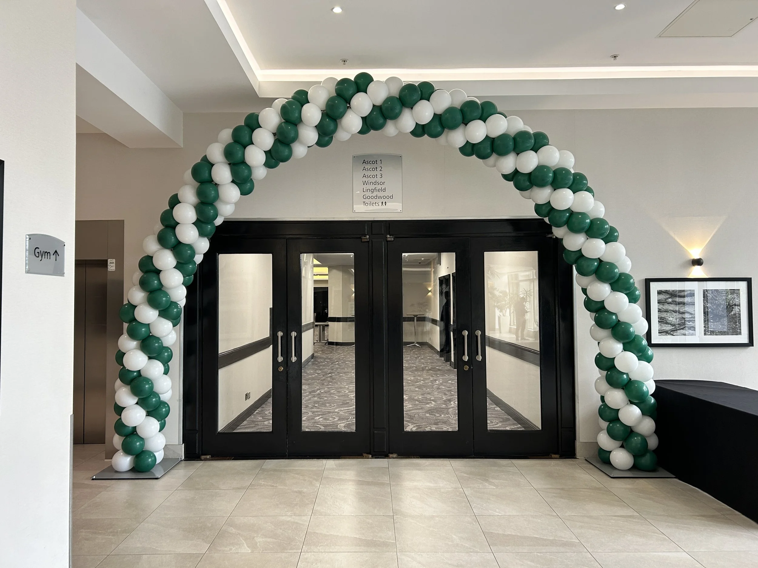green and white balloon garland for corporate fitness event