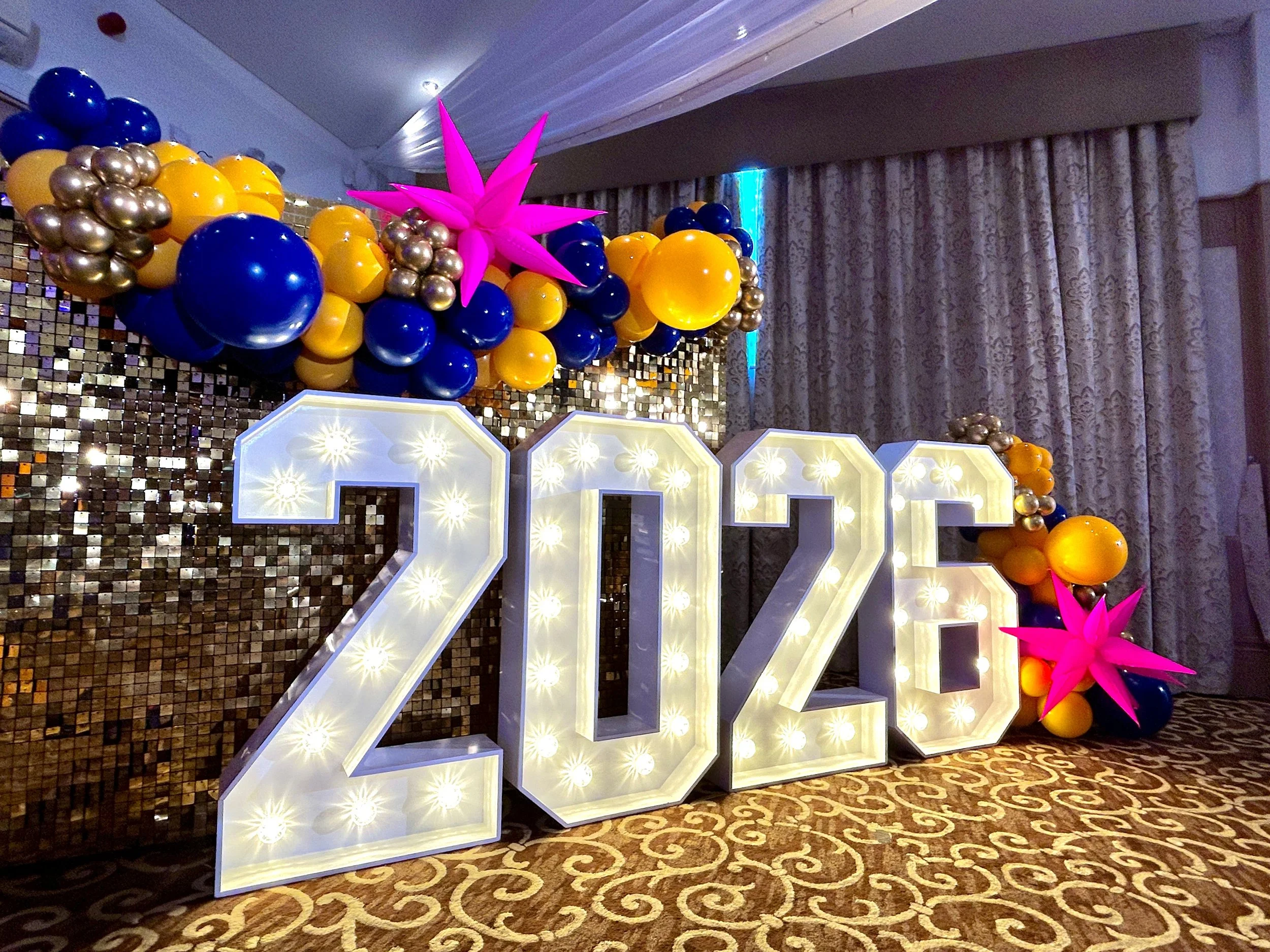 light up number with gold shimmer wall and balloon garland for the queen Victoria star awards at the felbridge hotel in east grinstead 