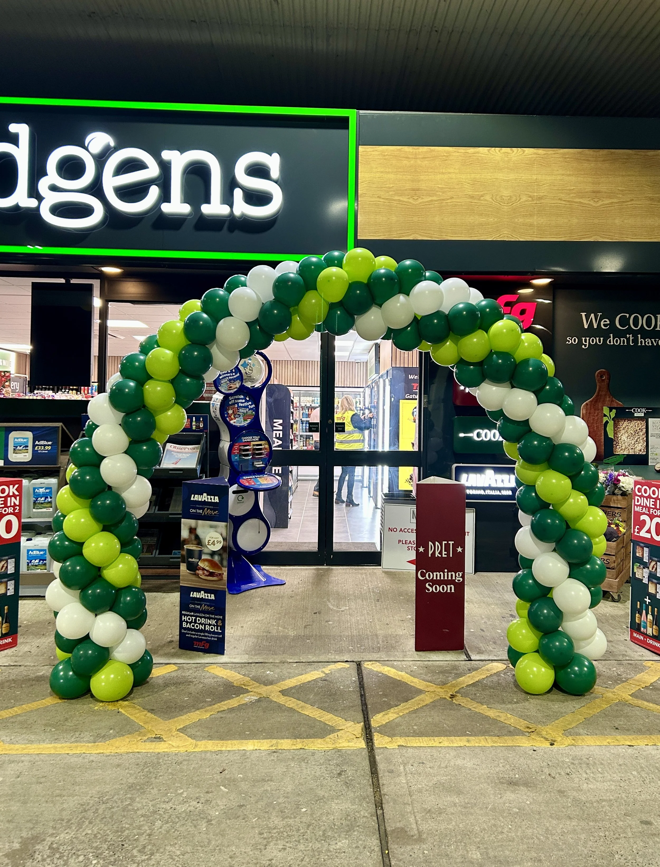 green and white balloon arch for a shop opening in gatwick