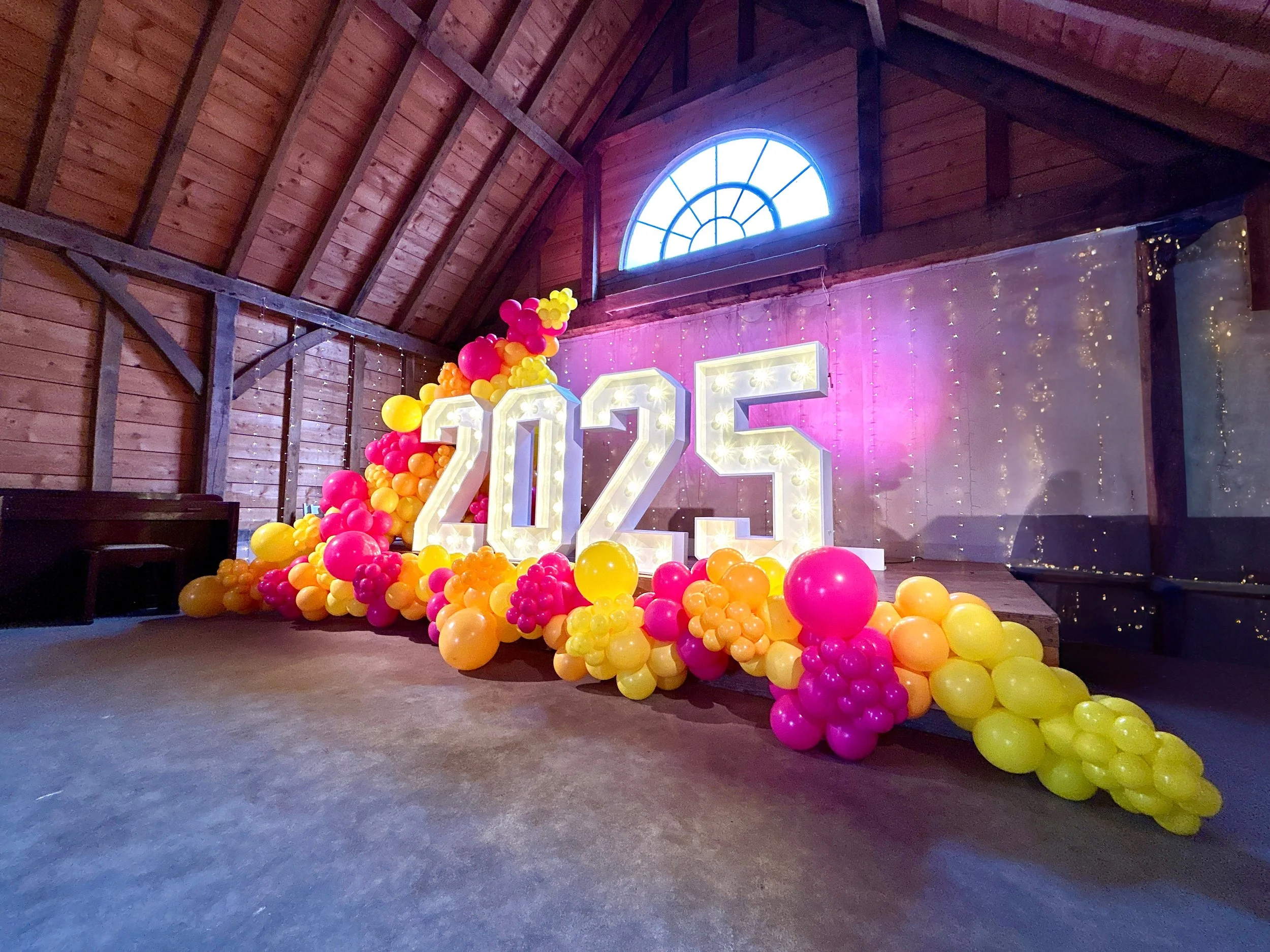 light up 2025 numbers with yellow and pink balloons at the yogurt rooms in east grinstead 
