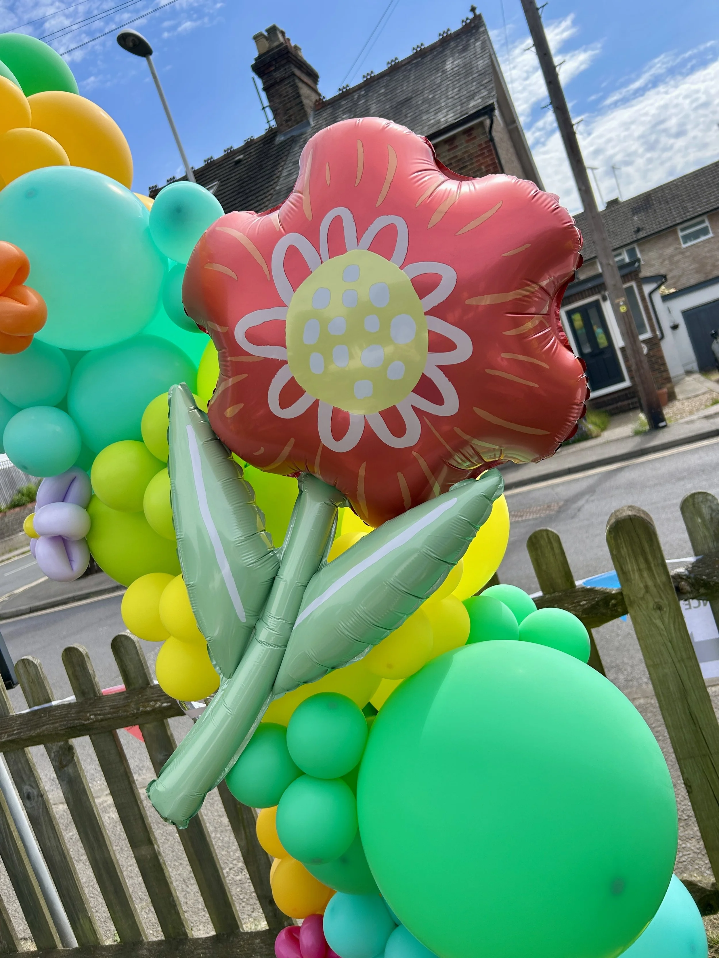 flower foil balloon on a spring themed balloon arch for a celebration at the old dunnings mill pub in east grinstead 