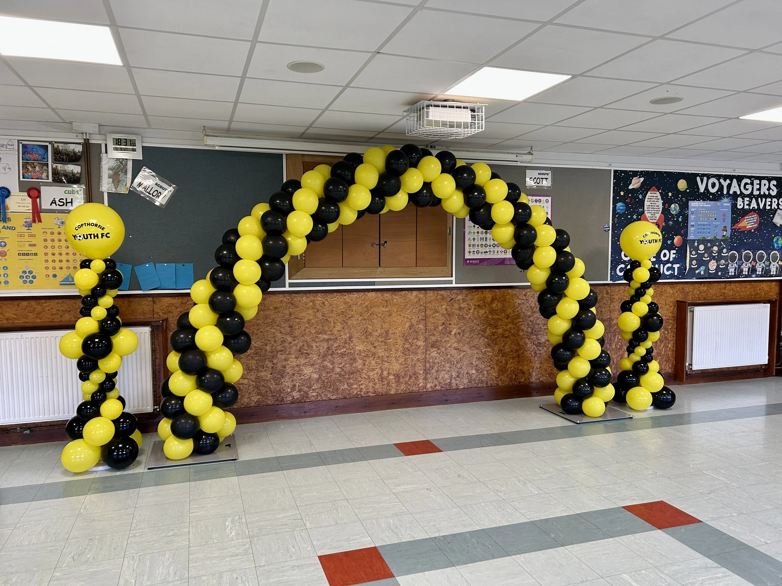 yellow and black balloon arch for a football awards ceremony