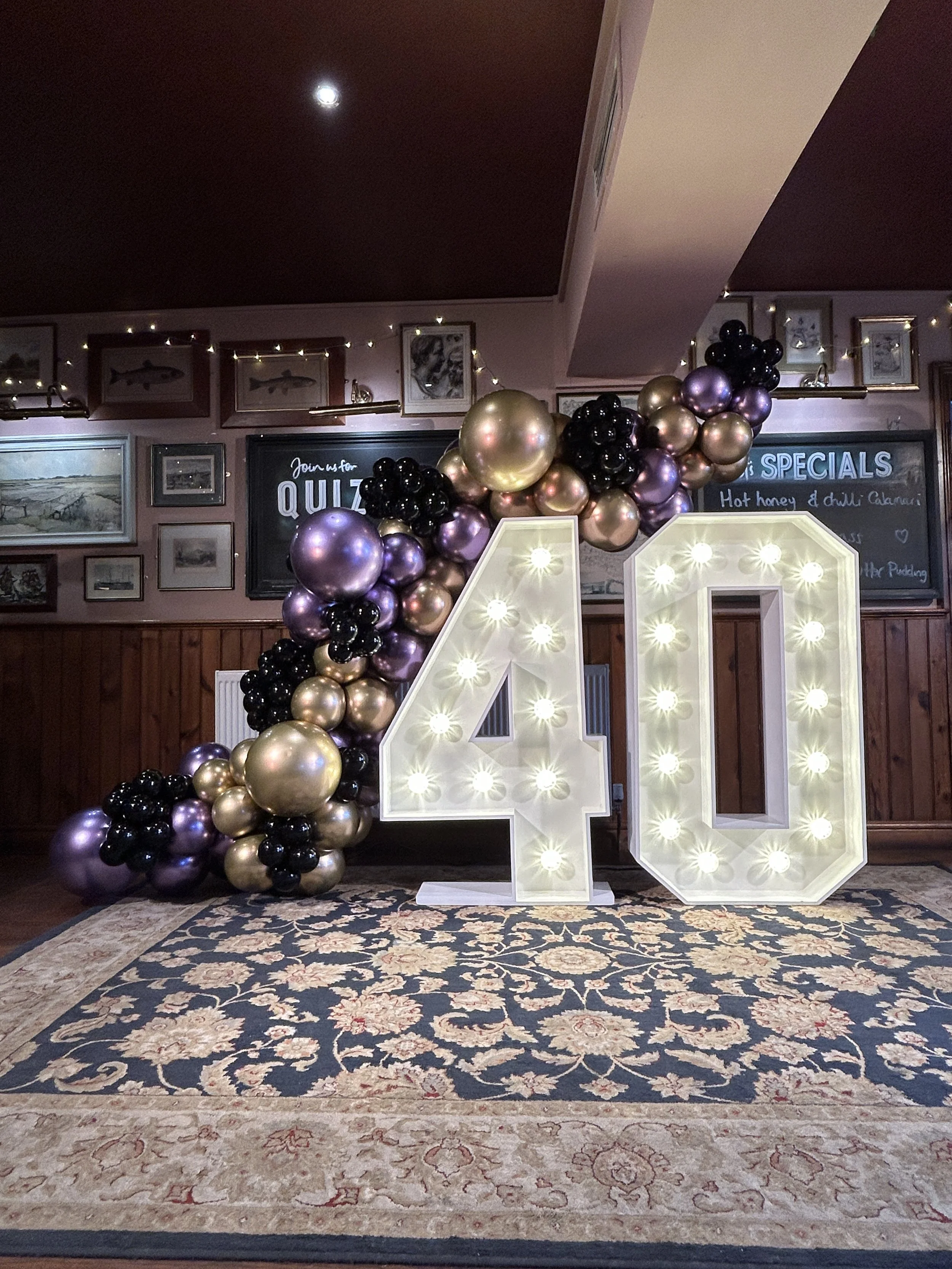 light up 40 in east grinstead with lilac black and gold balloons
