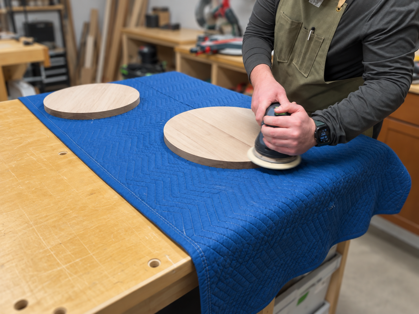Sanding a walnut end table in the workshop