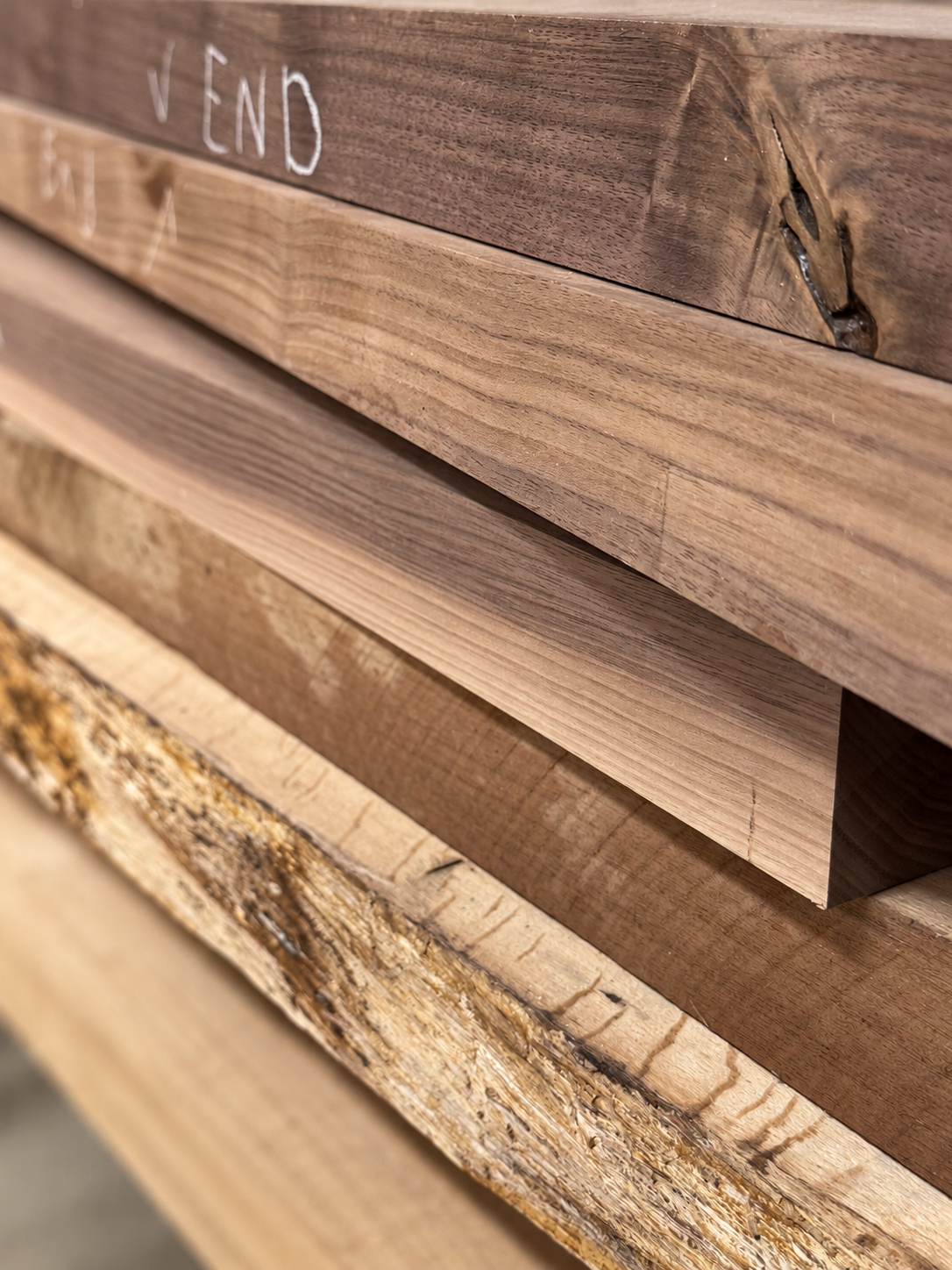 Stack of raw hardwood boards selected for a build