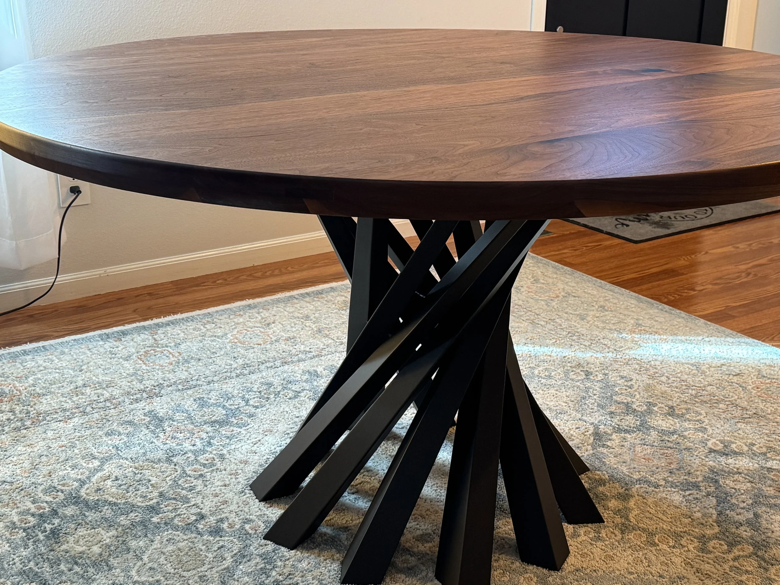 Handcrafted walnut dining table with steel base built in Iowa