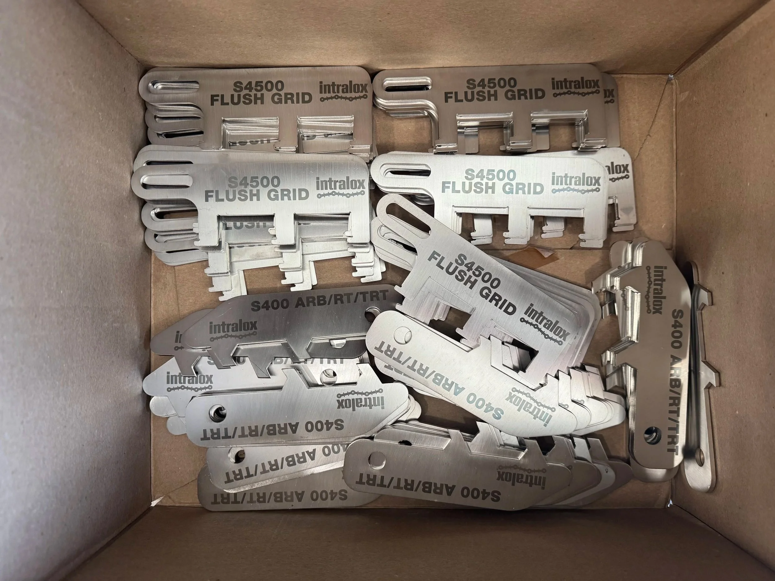 Laser annealed stainless steel industrial tags with permanent black marking for equipment identification.