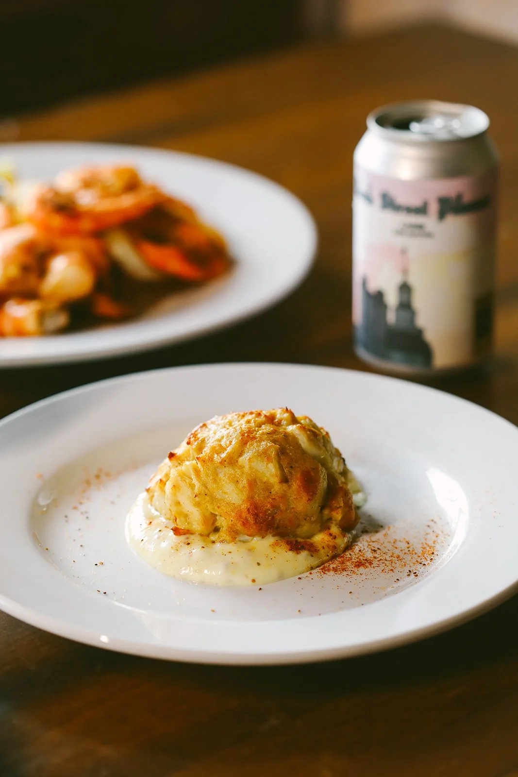 Crab cake appetizer served with homemade tartar and garnish on a small plate