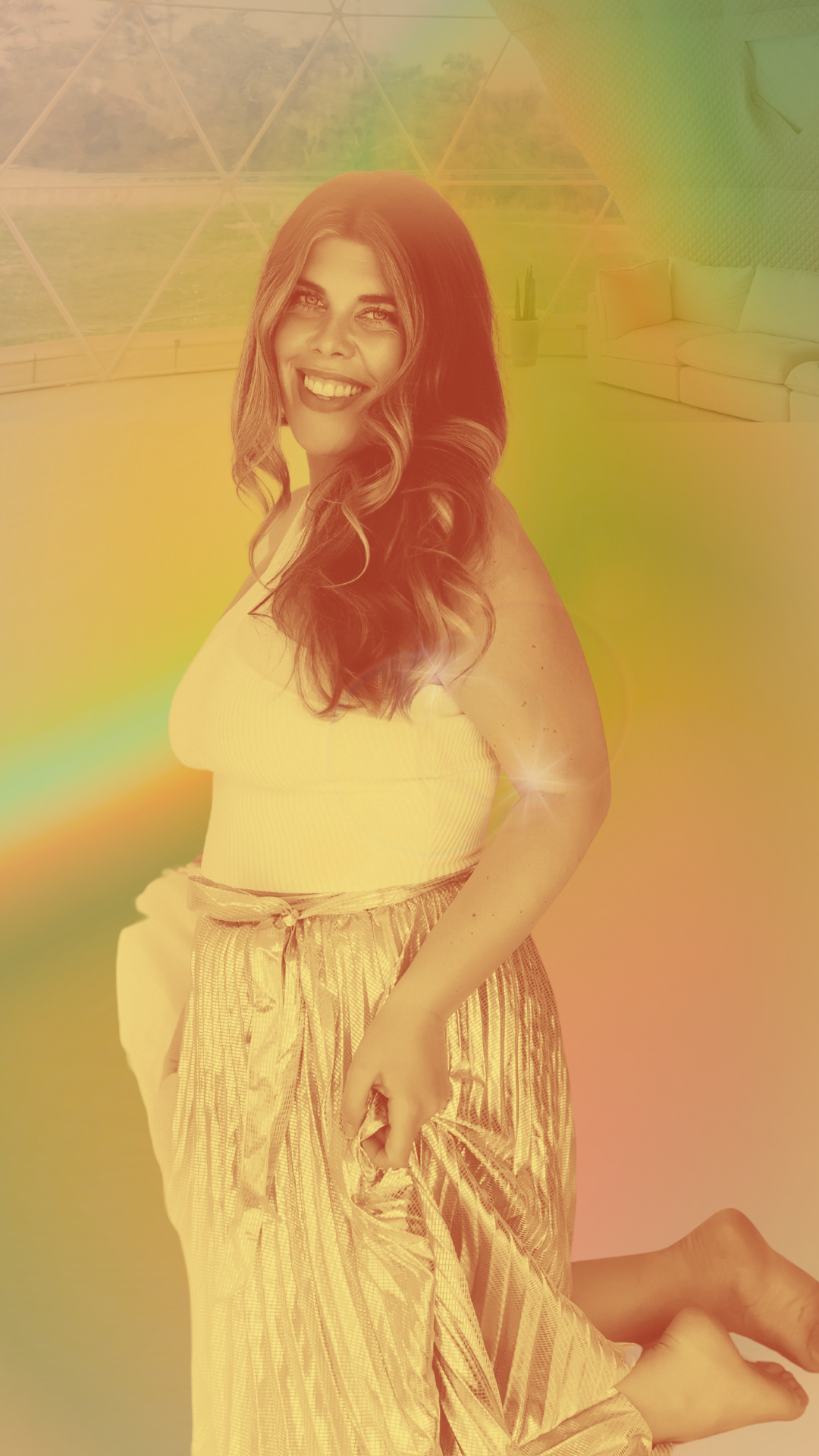 Jenna in the Geodome where she facilitates breathwork journeys. Jenna is wrapped in a warm rainbow prism of light.