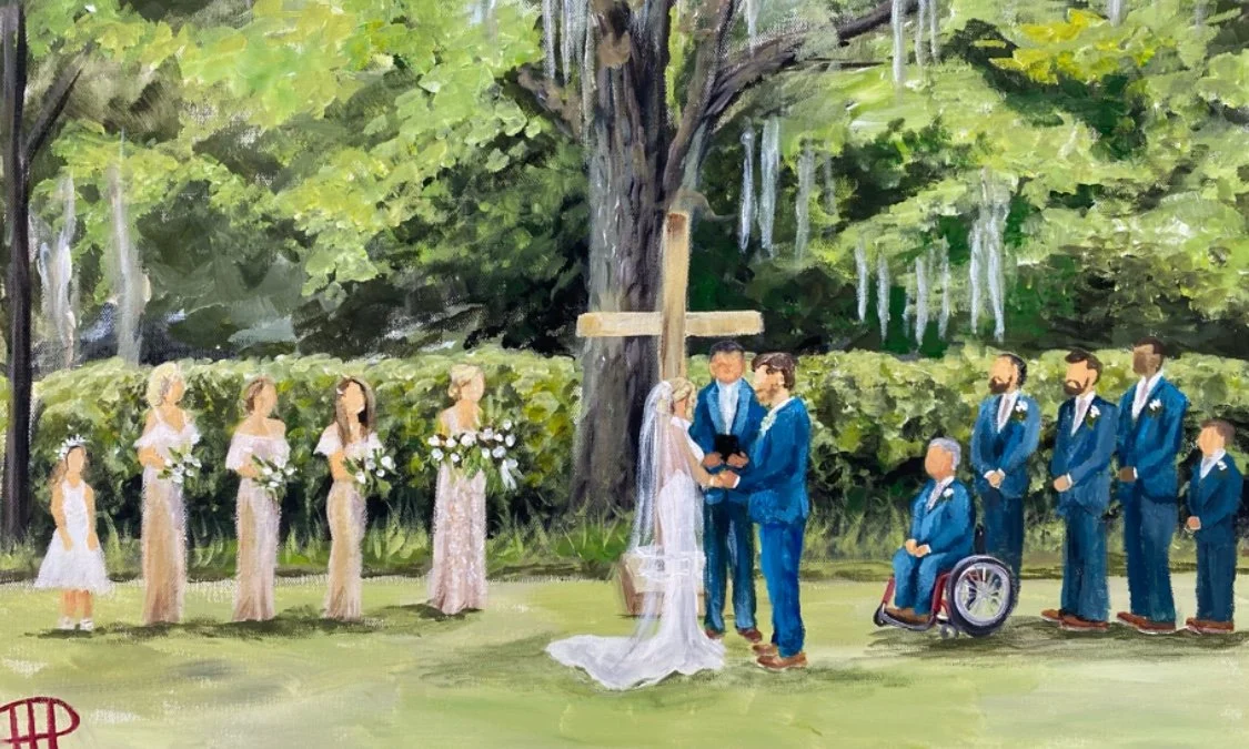 A wedding ceremony outdoors under a large tree with a wooden cross. The bride and groom stand at the center, holding hands and exchanging vows. The bride wears a veil and white dress, while the groom is in a blue suit. Bridesmaids in beige dresses ho
