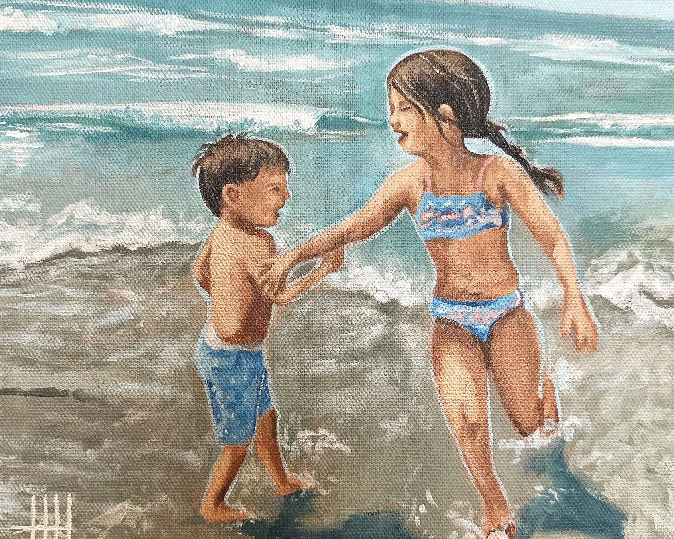 A woman and a young boy playing in the ocean waves at the beach, both smiling and holding hands.