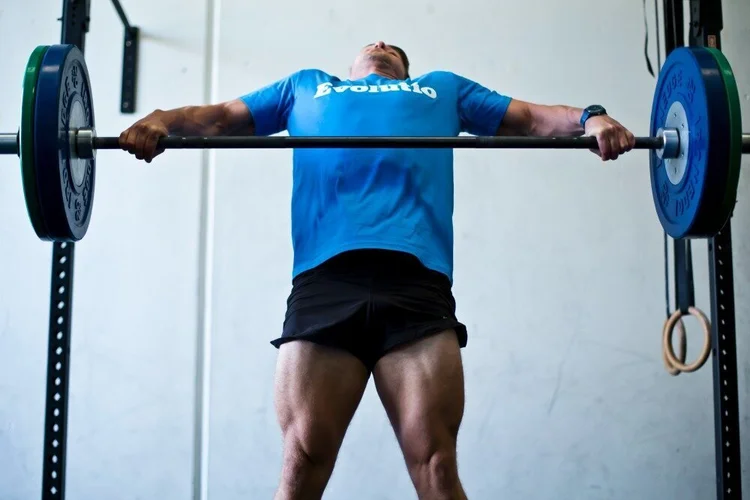 Athlete holding a barbell in the front rack position, the position that most commonly provokes wrist pain in CrossFit and Olympic lifting