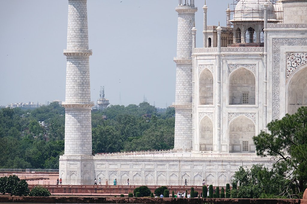 Those are people walking along the base of the Taj Mahal, i.e. it is big!