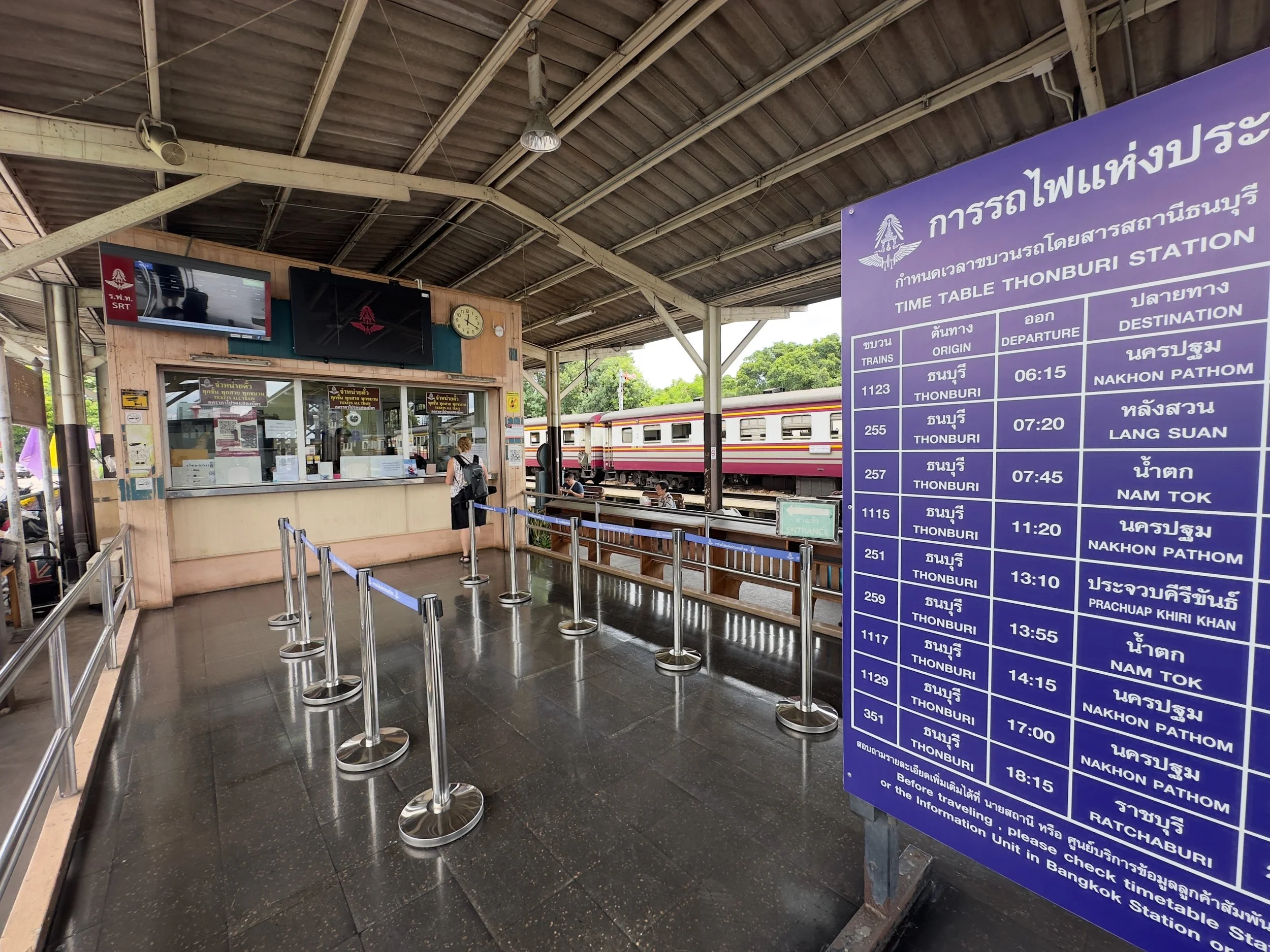 Getting tickets at Thon Buri Station with destination board ( we were on the 13:55 to Nam Tok )
