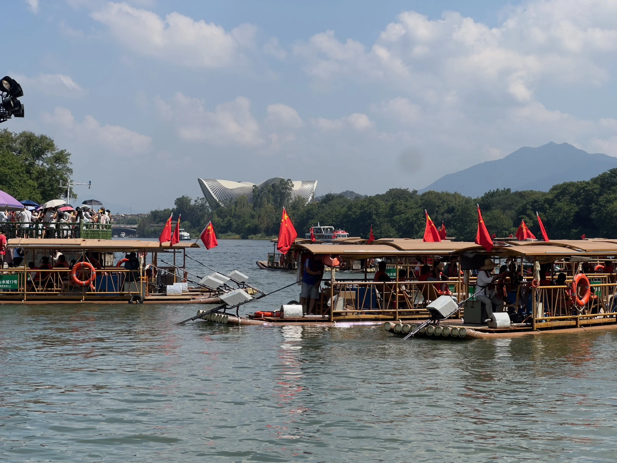Rafts on the Lijiang River wth the Opera House beyond, Elephant Hill Scenic Reserve