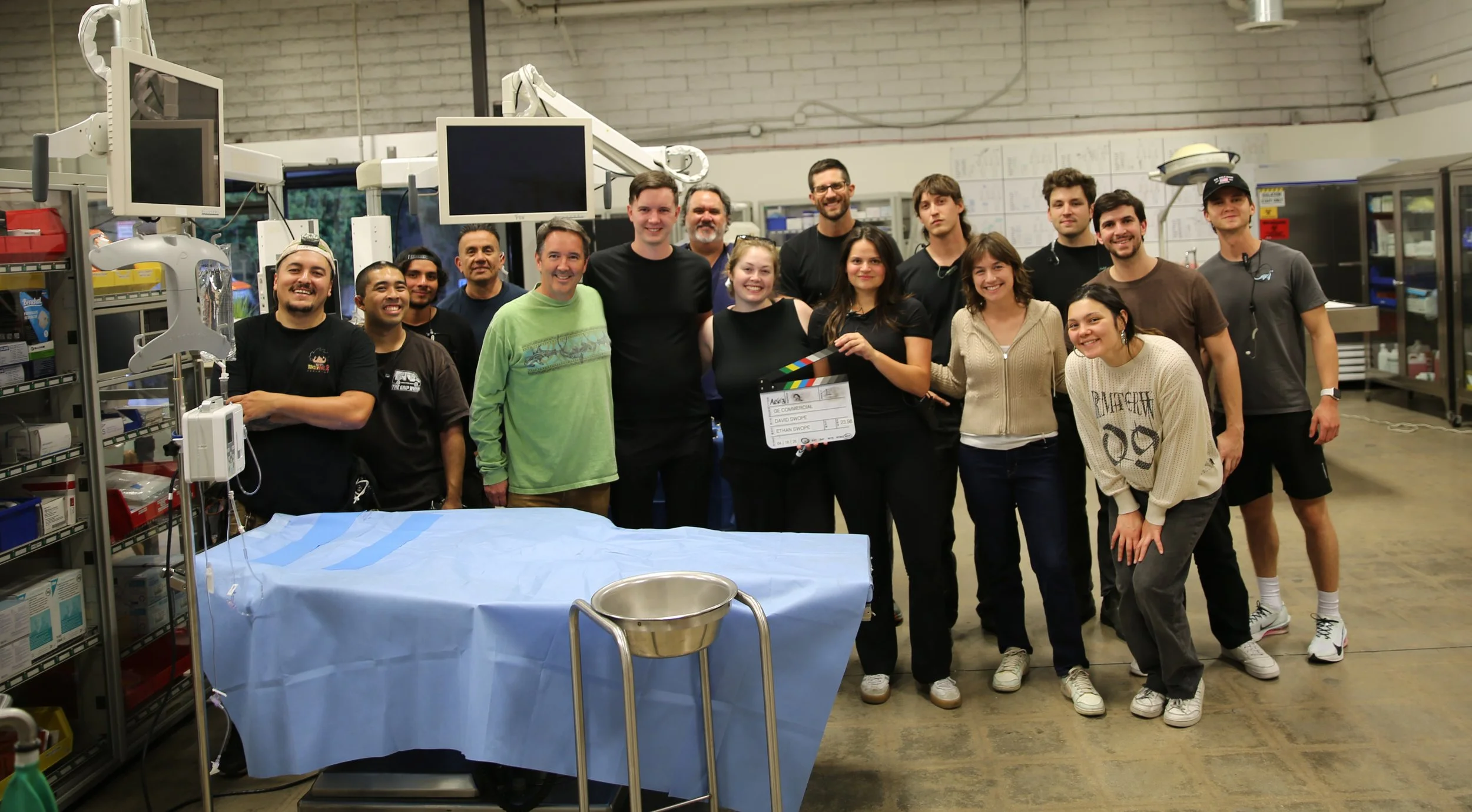 Swope Films production crew for GE's Care at the Core shoot, posing together in a hospital set with medical equipment and monitors in the background.
