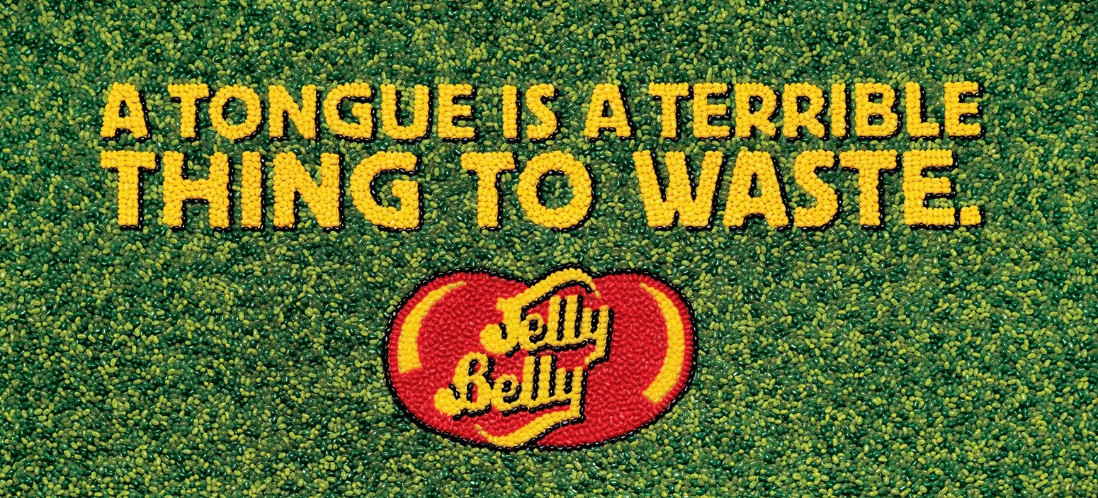 Billboards made of Jelly Bellies glued together (no AI). Headline reads "A tongue is a terrible thing to waste."."