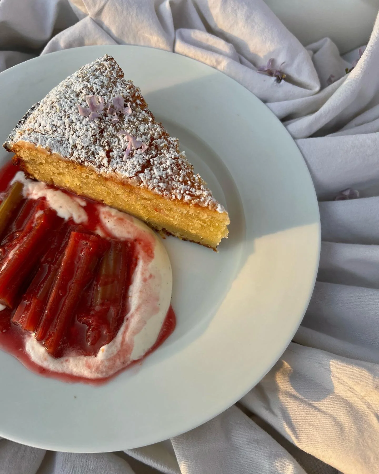 🌸Mothers day is right around the corner! Treat the mothers in your life or even yourself, to a delicious spring cake. Moist olive oil cake dusted with powdered sugar and edible flowers, a light fresh whipped cream and tart poached rhubarb syrup🌸

T