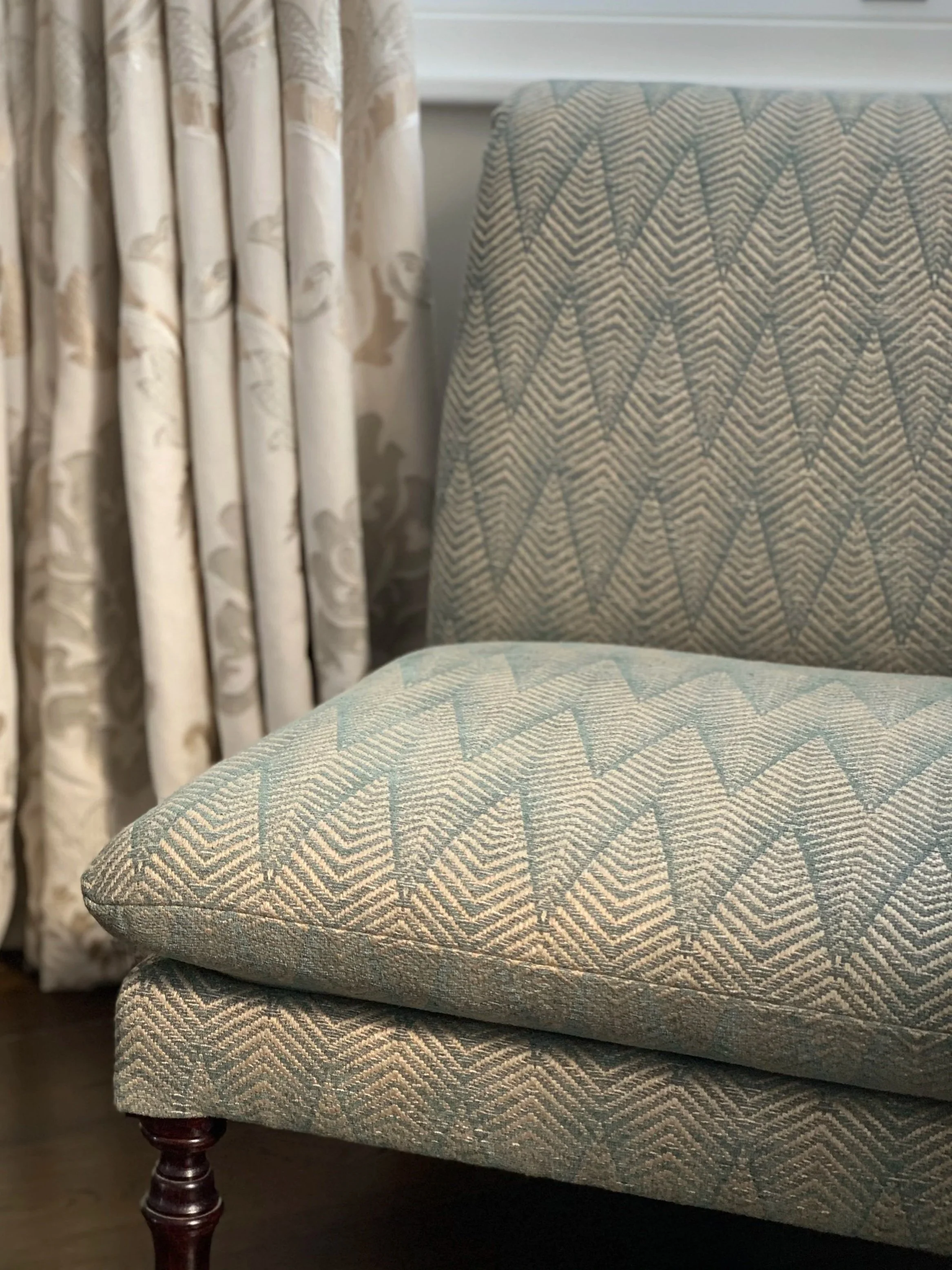 Slipper chair upholstered in a green chevron weave