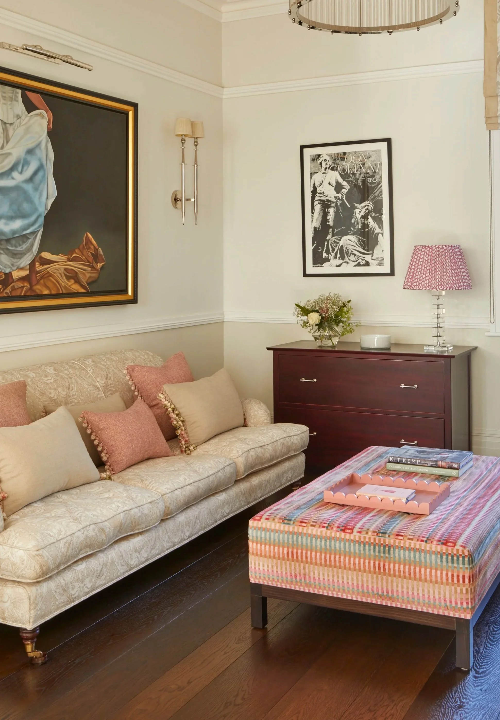 Upholstered sofa and colourful striped ottoman in a Clapham sitting room