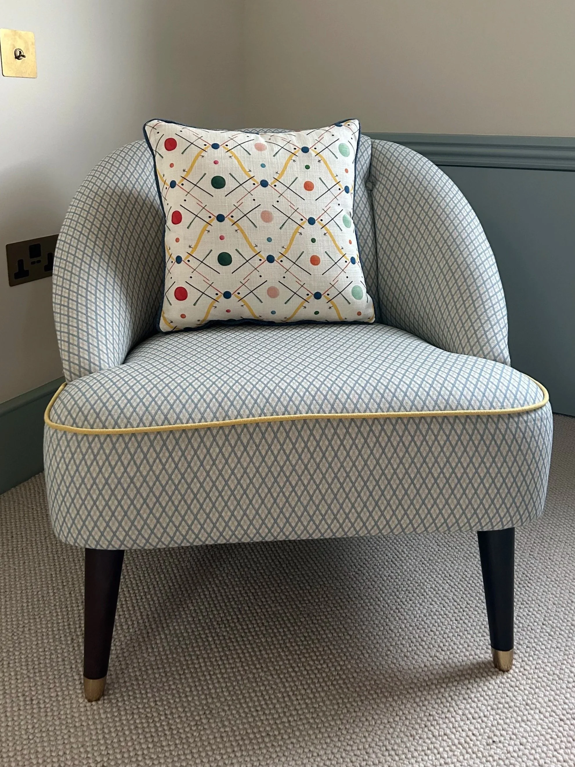 Tub chair in a blue trellis weave by Ottoline with yellow contrast piping