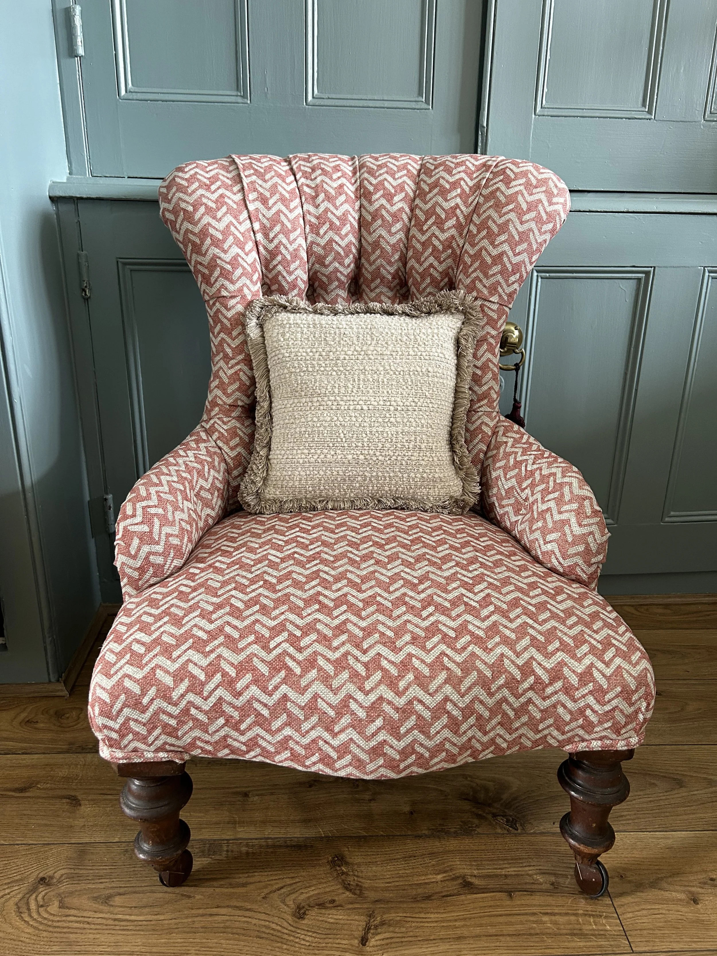 Victorian buttoned armchair reupholstered in a pink chevron weave by Fermoie